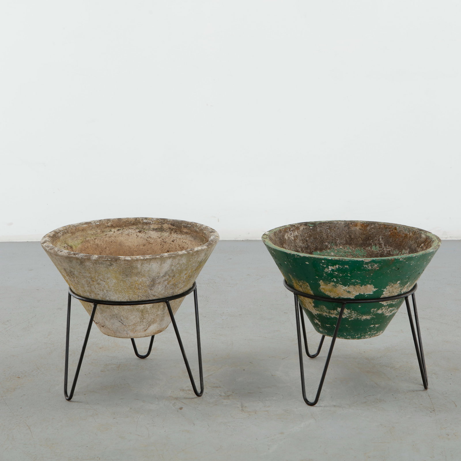 Willy Guhl, Pair of Conical Planters on Stands, 1960s: Iconic Willy Guhl silhouettes in compact form, these conical planters rest atop minimalistic metal stands, weathered yet timeless. Height: 19.5 in. Diameter: 22 in.