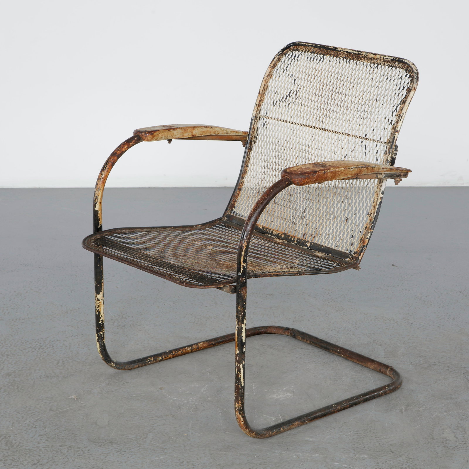 Outdoor Mesh Lounge Chair in the style of Woodard, 1950s: Outdoor lounge chair constructed from welded steel and expanded metal mesh. Its airy silhouette and weathered patina embody the charm of midcentury American garden furniture. Height: 32 in. Width: 25 