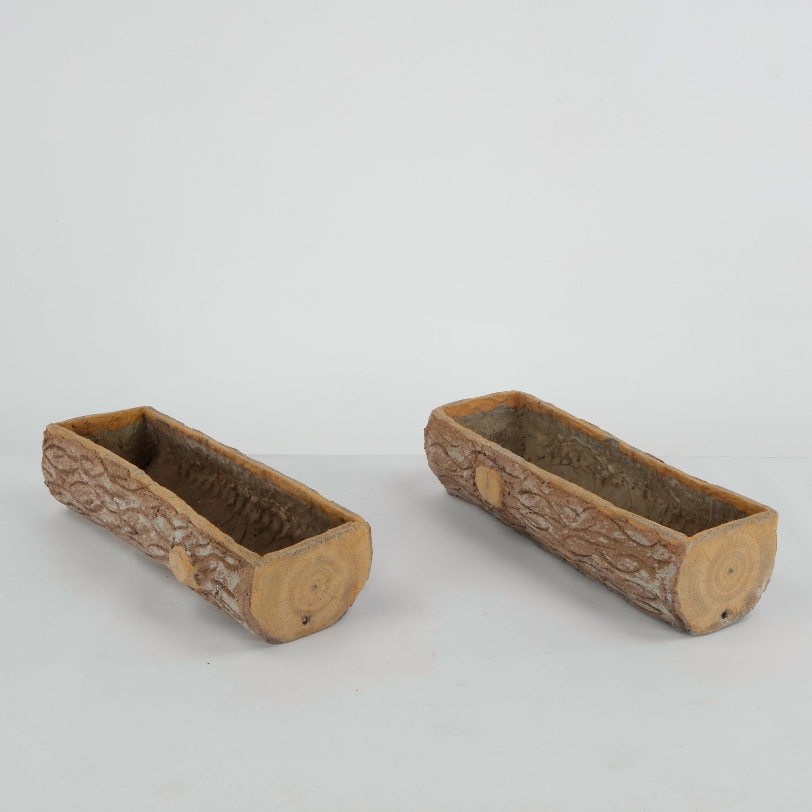 Pair of Faux Bois Planters, 1960s: A pair of hand-cast faux bois planters skillfully modeled to imitate tree trunks with convincing bark texture. Fine examples of French garden craftsmanship, combining rustic charm with enduring durabi