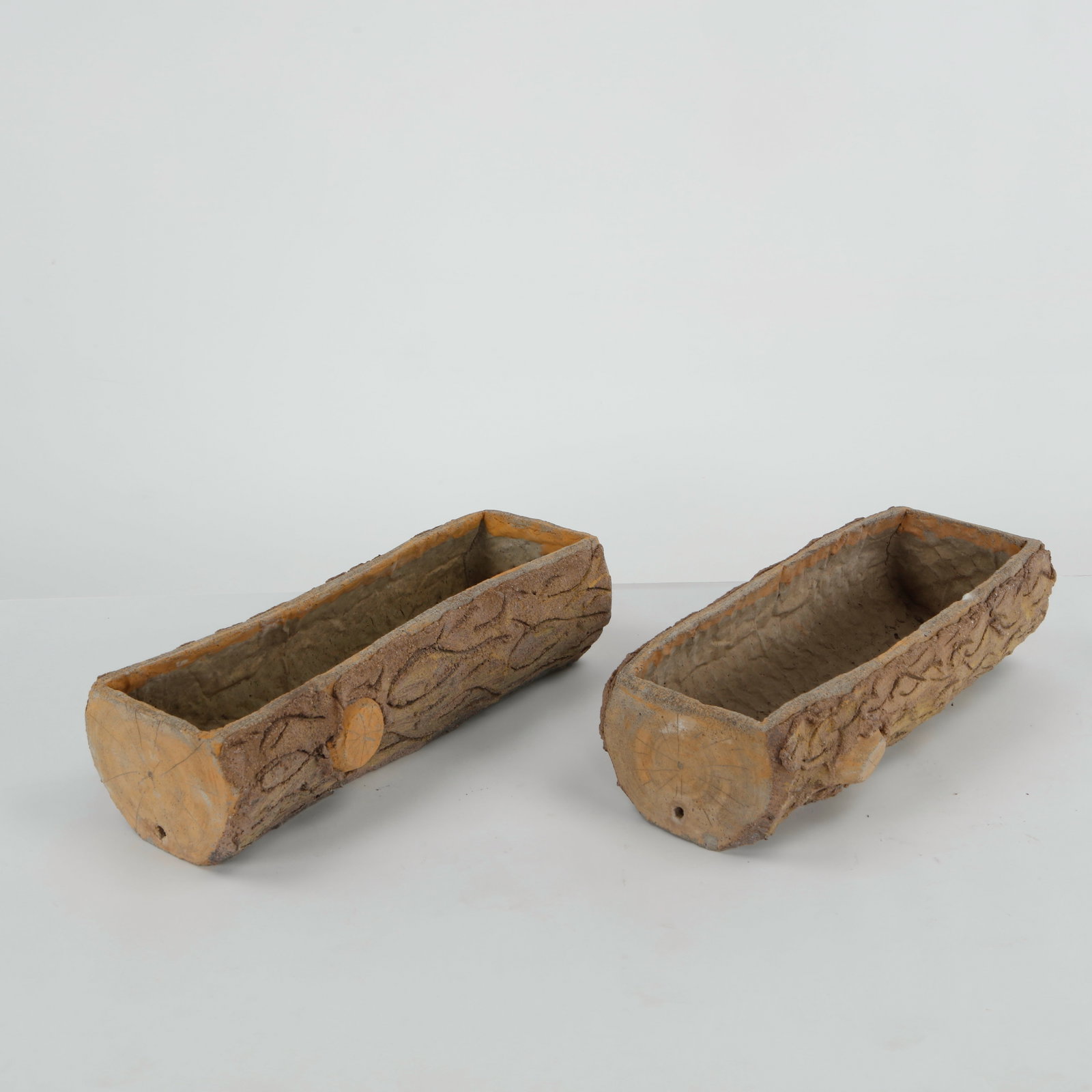 Pair of Faux Bois Planters, 1960s: A pair of hand-cast faux bois planters skillfully modeled to imitate tree trunks with convincing bark texture. Fine examples of French garden craftsmanship, combining rustic charm with enduring durabi