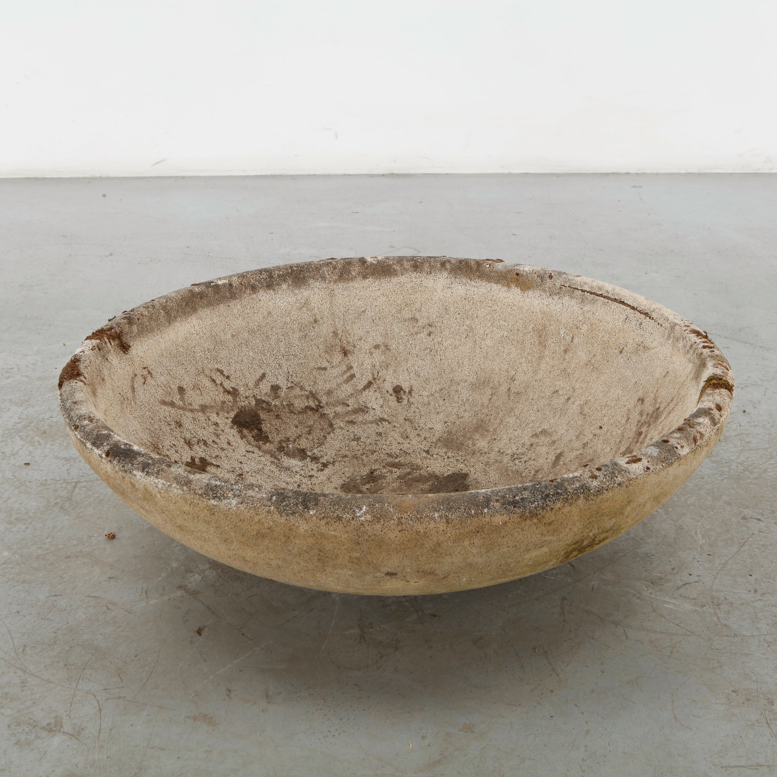 Monumental Cast Stone Planter, 1960s: A substantial cast stone bowl planter with a broad, softly rounded profile and finely weathered surface. Its generous proportions and restrained form lend a monumental quality to this utilitarian