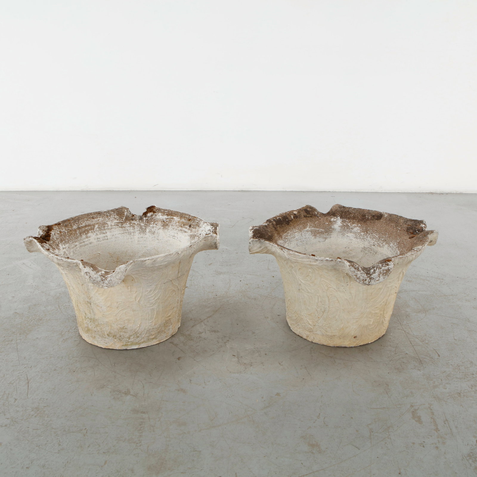 Grandon Fres, Pair of Sculptural Planters, 1960s: A rare pair of sculptural planters by Grandon Fres, executed in cast concrete with expressive, irregular rims and softly incised organic surfaces. Their weathered patina lends the forms a distinctive