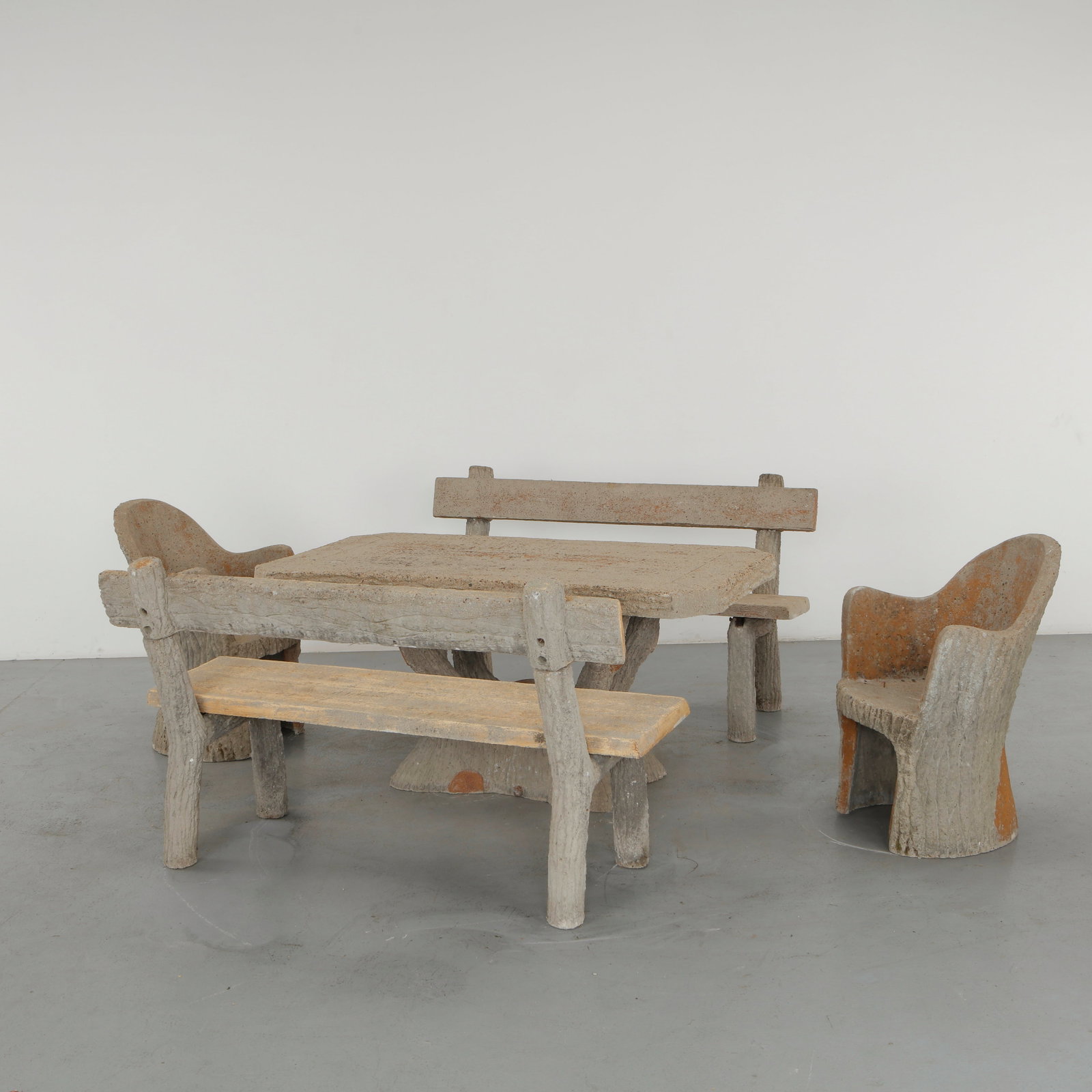 Faux Bois Concrete Outdoor Dining Set, 1960s: A rare sculptural outdoor dining ensemble executed in concrete with a convincing faux bois treatment. Comprising a table, benches and armchairs, the set transforms a traditionally rustic vocabulary in