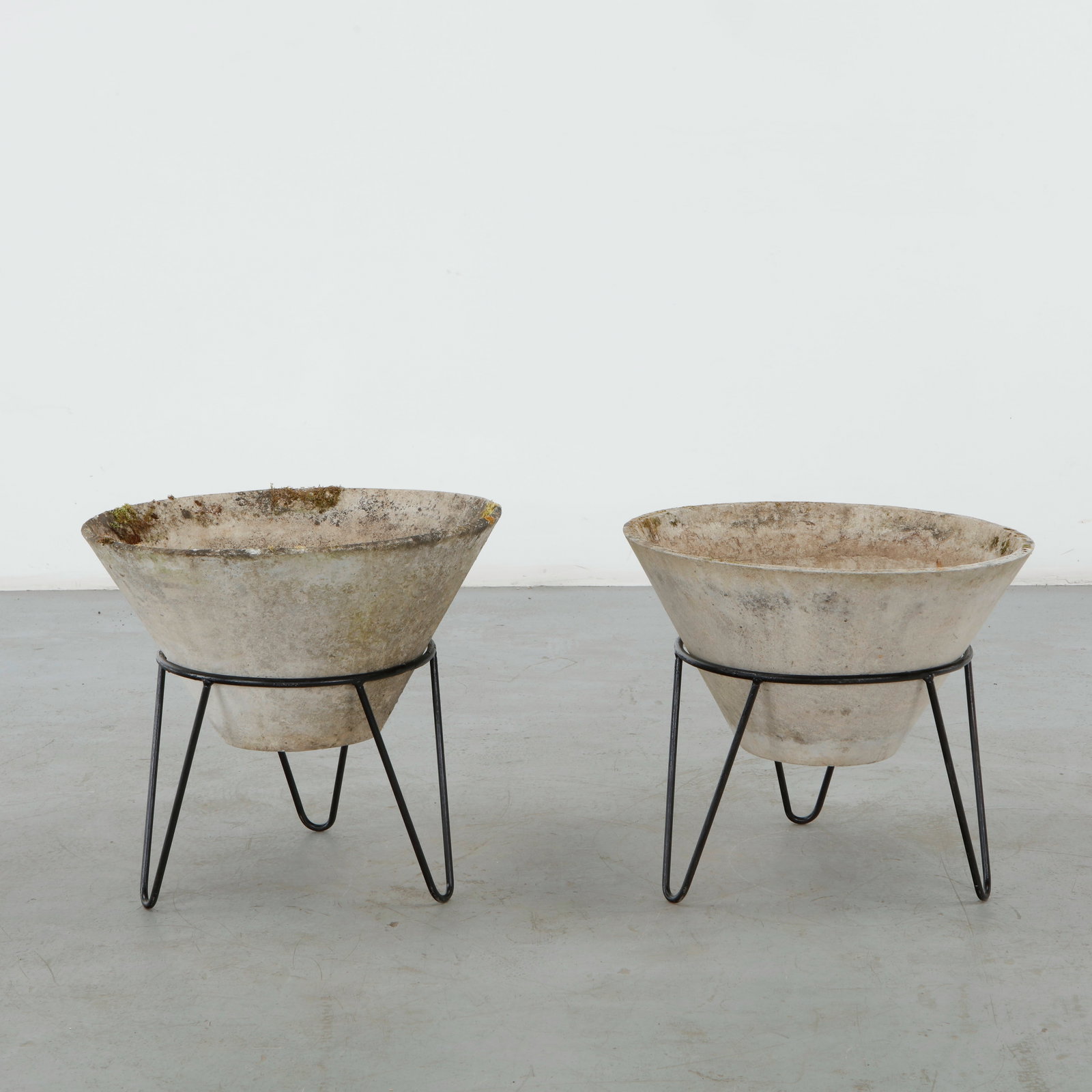 Willy Guhl, Pair of Conical Planters on Stands, 1960s: Iconic Willy Guhl silhouettes in compact form, these conical planters rest atop minimalistic metal stands, weathered yet timeless. Height: 19.5 in. Diameter: 22 in.