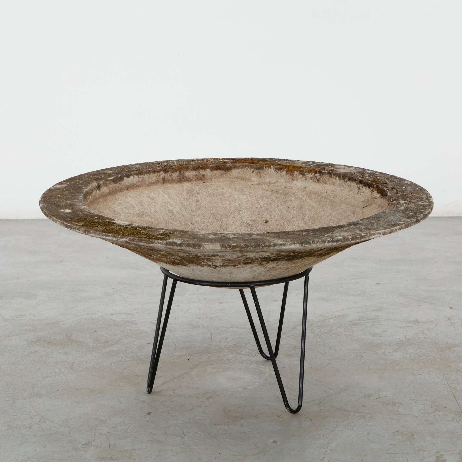 Willy Guhl, Bowl Planter on Stand, 1960s: A wide concrete bowl elevated on a minimalist black metal stand, combining substantial materiality with a light, floating silhouette. The aged surface enhances its restrained modernist character. Heig