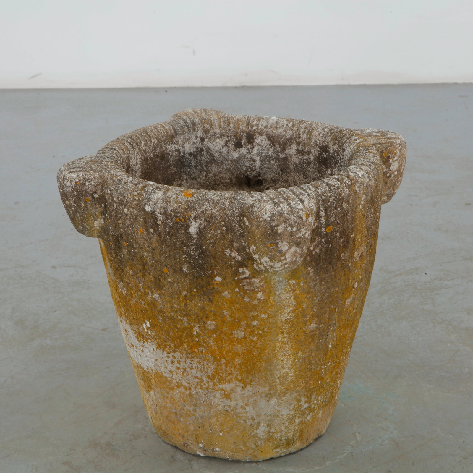 Large Stone Urn Planter, 1960s: A Large cast stone urn planter with a classical silhouette, broad rim, and substantial rounded body. The richly weathered surface and natural oxidation impart an exceptional sense of age and