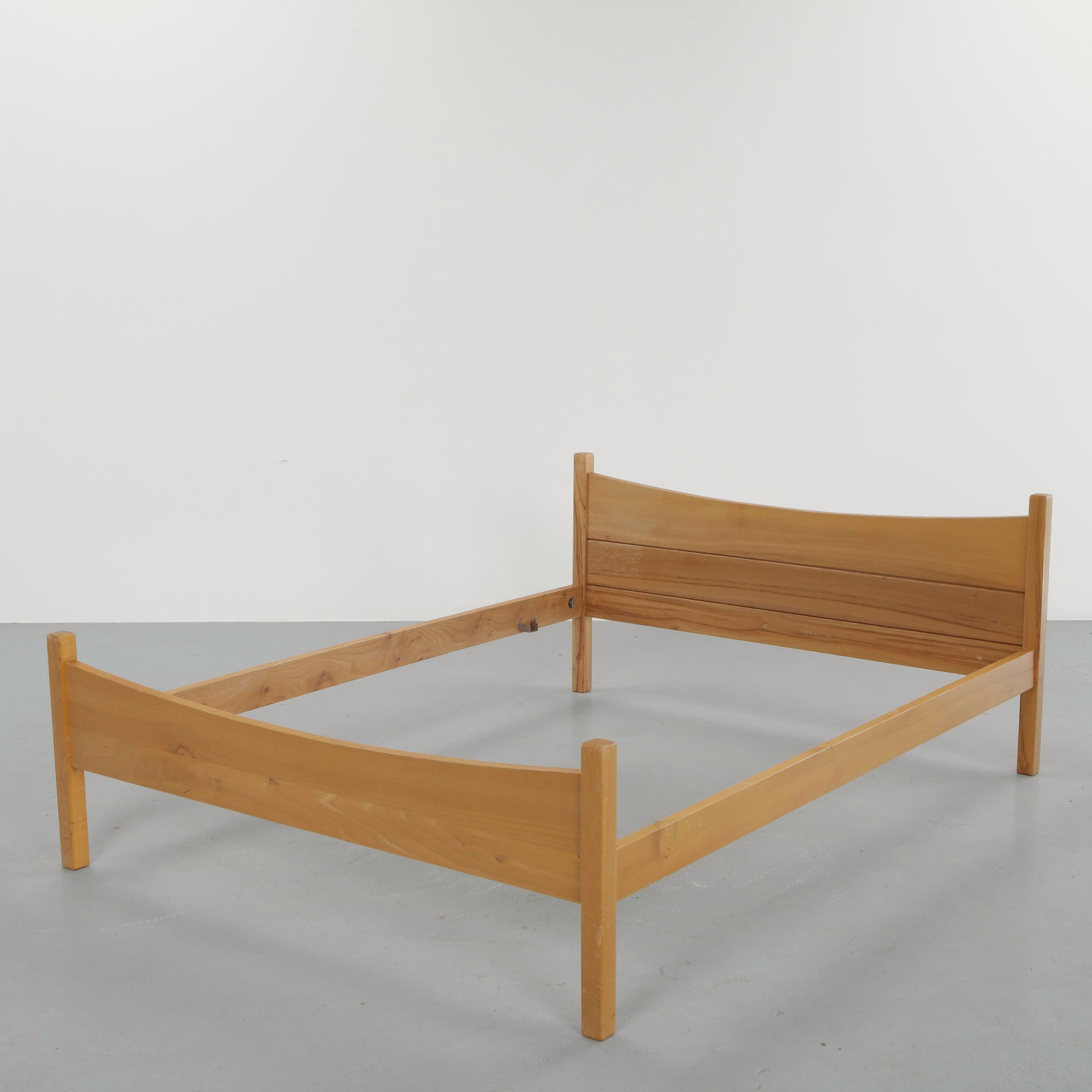 French Midcentury Solid Pine Full Bedframe, 1960s: Crafted in solid pine, this bed reflects the warmth and simplicity of midcentury French design. The gently curved headboard and footboard create a subtle architectural presence, while the clean lines