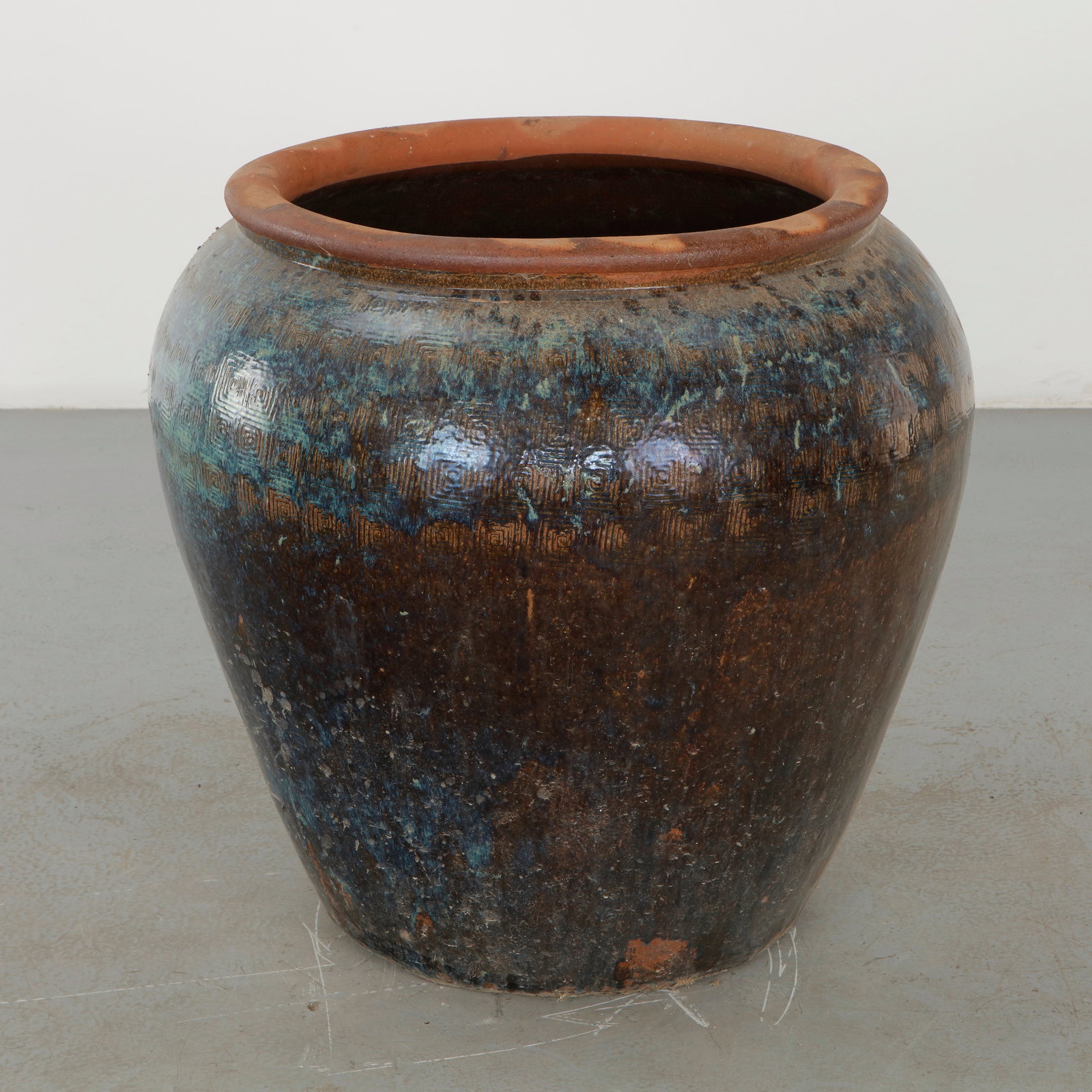 Large Glazed Ceramic Planter with Geometric Decoration, 1960s: Large rounded ceramic planter distinguished by a richly variegated dark glaze in blue, brown and green tones, enhanced by a repeated incised geometric motif. The substantial vessel combines an