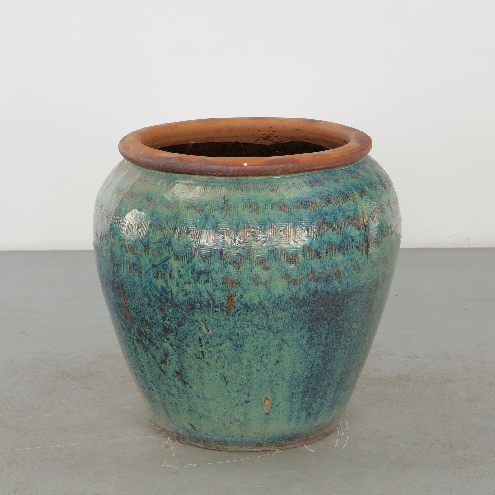 Large Glazed Ceramic Planter with Turquoise Geometric Band, 1960s: Large rounded ceramic planter distinguished by a richly variegated dark glaze in blue, brown and green tones, enhanced by a repeated incised geometric motif. The substantial vessel combines an