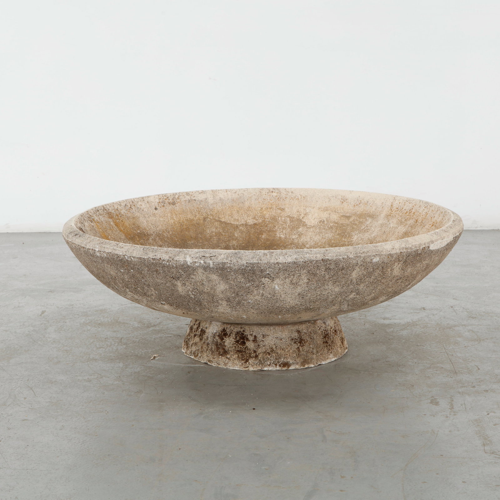 Monumental Cast Stone Bowl on Pedestal, 1960s: Monumental cast stone bowl planter with a broad, gently rounded basin supported on a substantial pedestal base. Its heavily weathered surface lends the piece a sculptural, architectural presence.