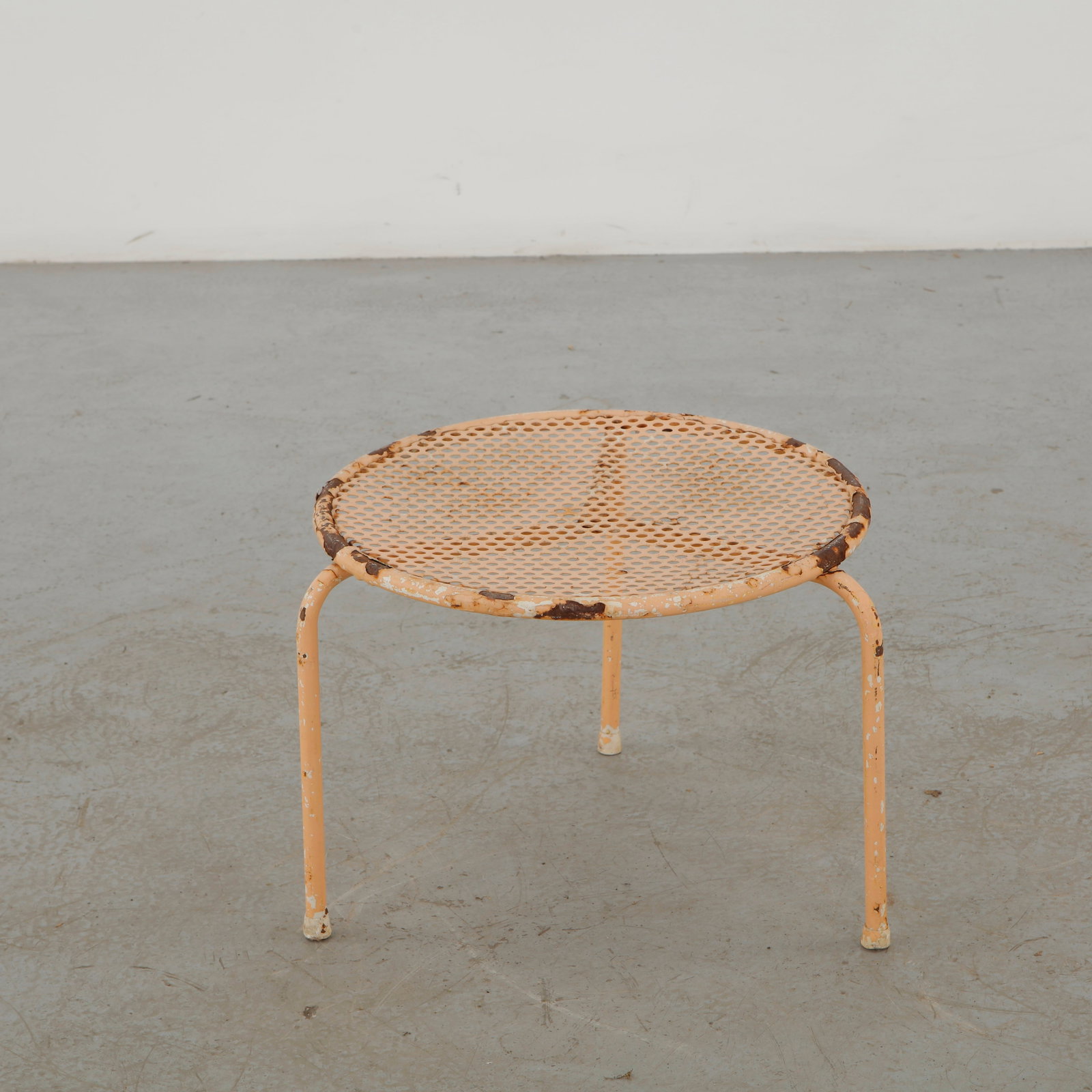 EMU, Round Wrought Iron Garden Table, Italy, 1960s: Italian garden table by EMU, featuring a circular perforated metal top supported by a slender tubular steel frame. The extensively weathered painted finish reveals successive layers of color and corro