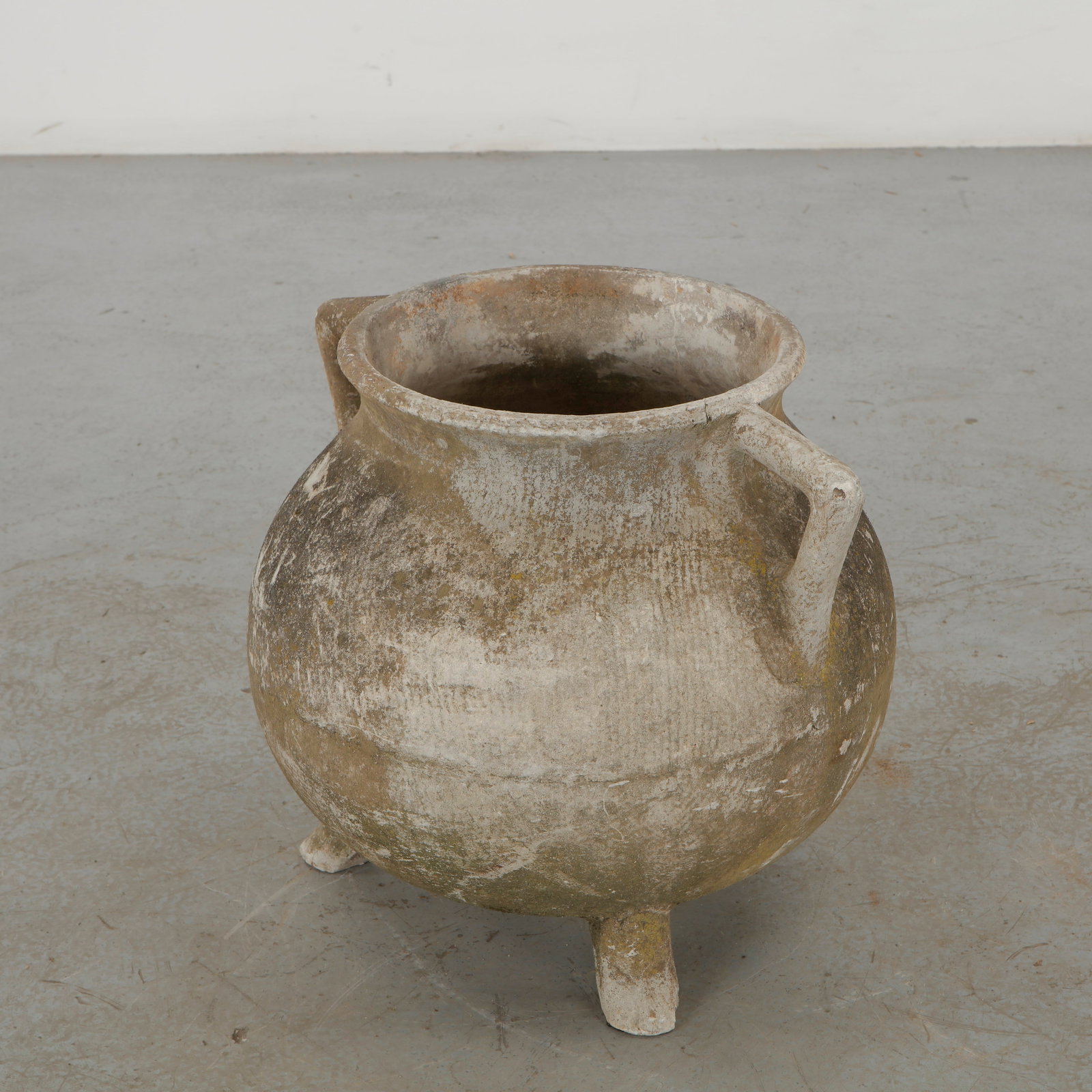 Willy Guhl, Cauldron Planter, 1960s: Willy Guhl cauldron planter distinguished by its generously rounded vessel, integrated feet and broad projecting rim. The heavily weathered concrete surface enhances its primitive, almost