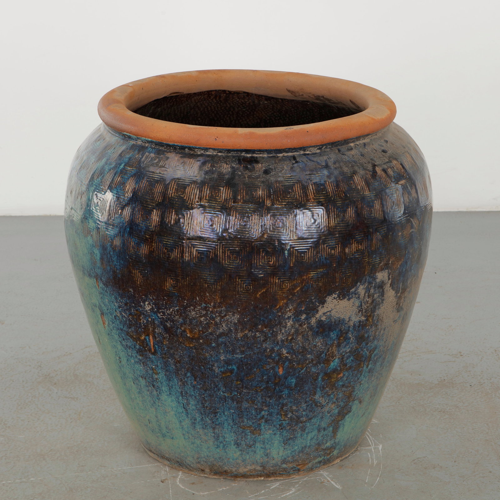Large Glazed Ceramic Planter with Turquoise Geometric Band, 1960s: Large rounded ceramic planter distinguished by a richly variegated dark glaze in blue, brown and green tones, enhanced by a repeated incised geometric motif. The substantial vessel combines an
