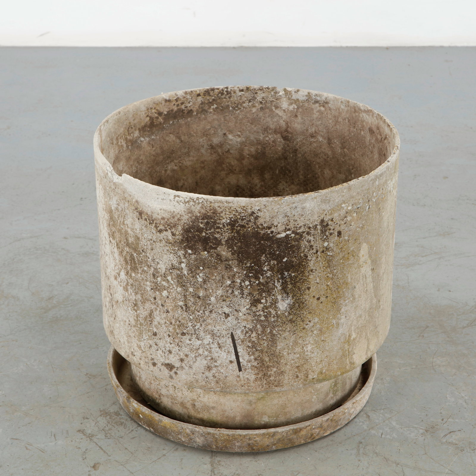Willy Guhl, Round Planter with Saucer, 1960s: Willy Guhl round concrete planter accompanied by a separate circular saucer, distinguished by its restrained modernist form and substantial construction. The naturally weathered surface enhances its