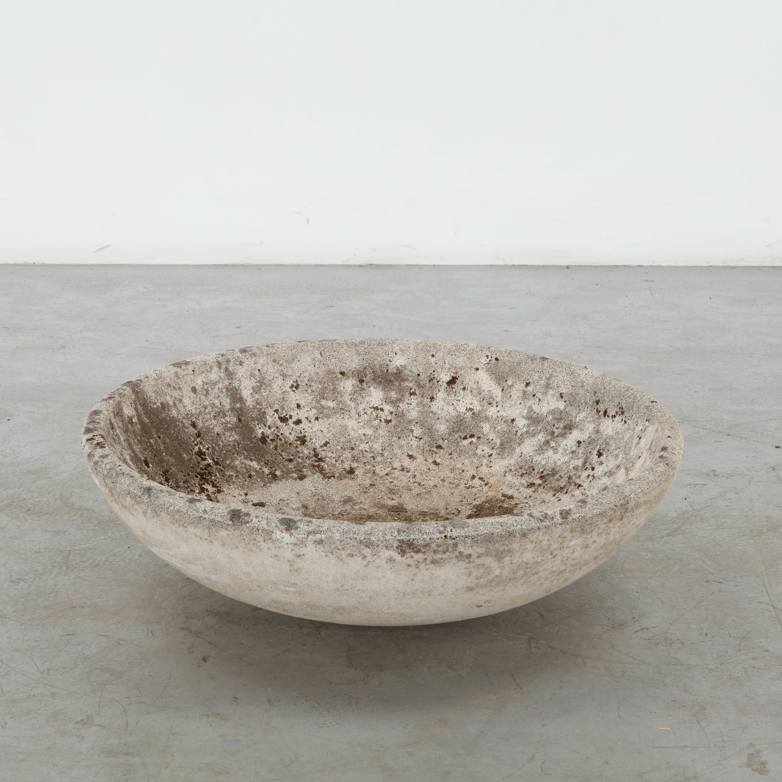Large Cast Stone Bowl Planter, 1960s: A substantial cast stone bowl planter with a broad, softly rounded profile and finely weathered surface. Its generous proportions and restrained form lend a monumental quality to this utilitarian