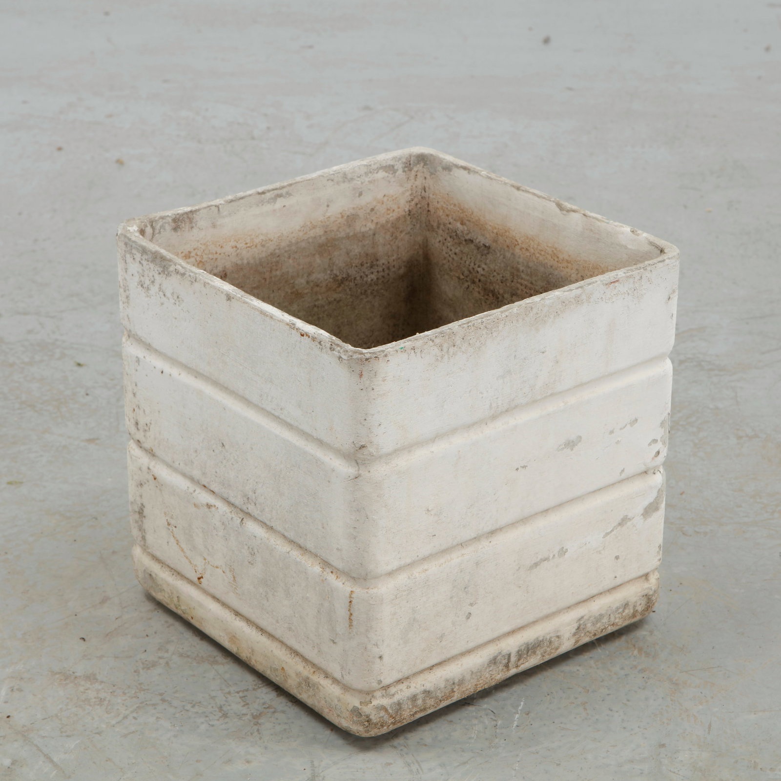 Willy Guhl, Square Planter with Ribbed Form, 1960s: A geometric concrete planter distinguished by a series of broad horizontal bands that articulate its otherwise austere square volume. The weathered finish enhances its architectural character,