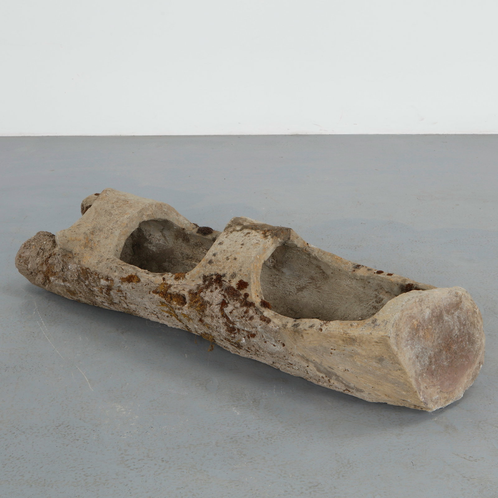 Monumental 4-Foot Faux Bois Log Planter, 1960s: Sculptural concrete planter executed in the faux bois tradition, featuring a hollowed trunk form with hand modeled bark detailing and an elongated architectural silhouette. The naturally aged surface 