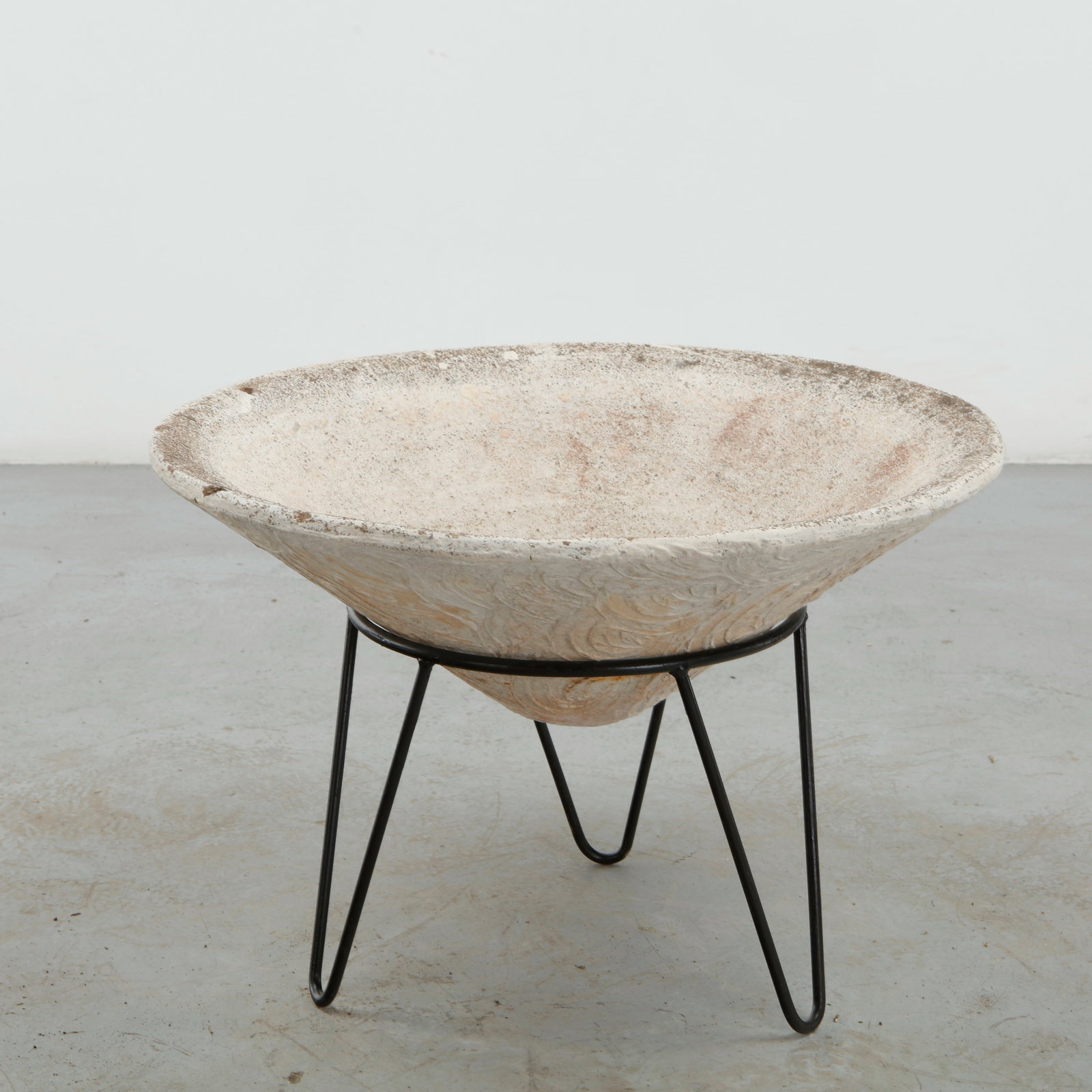 Grandon Fres, Conical Planter on Stand, 1960s: A sculptural concrete planter with a broad, shallow basin elevated on a slender black metal stand. The contrast between the monumental mineral form and delicate wire-like support creates a distinctly 