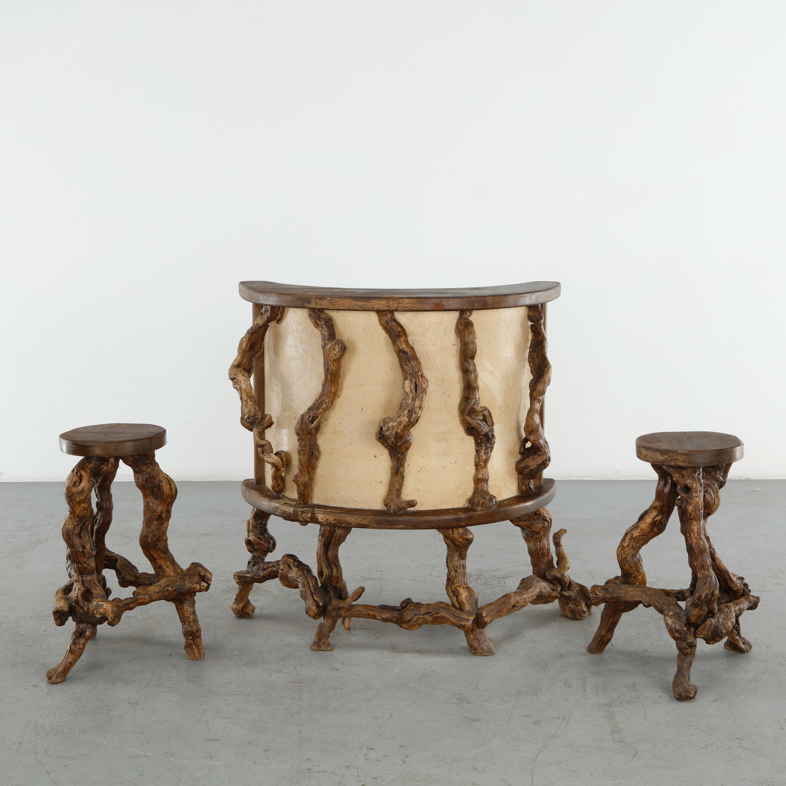 Root Wood Bar Cabinet and Matching Stools, 1960s: Striking outdoor bar set in natural root wood, comprising a cylindrical bar cabinet and two matching stools, each supported by sculptural, irregular branch-like forms. The expressive use of naturally 
