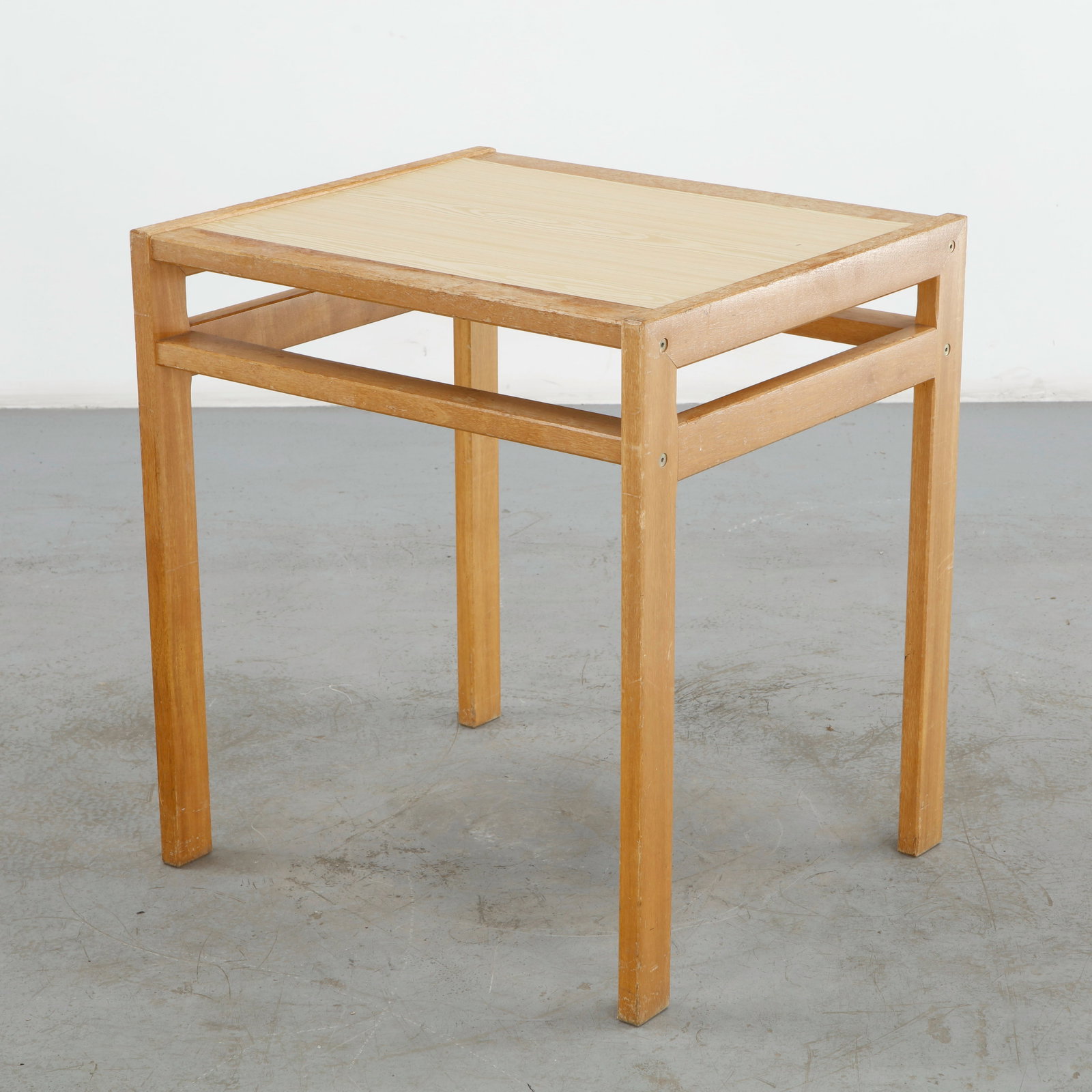 Side Wood Table Attributed to Alvar Aalto, 1950s: Elegant occasional table attributed to Alvar Aalto, executed in warm-toned wood with a restrained geometric construction. Its softly rounded edges and balanced proportions reflect the enduring