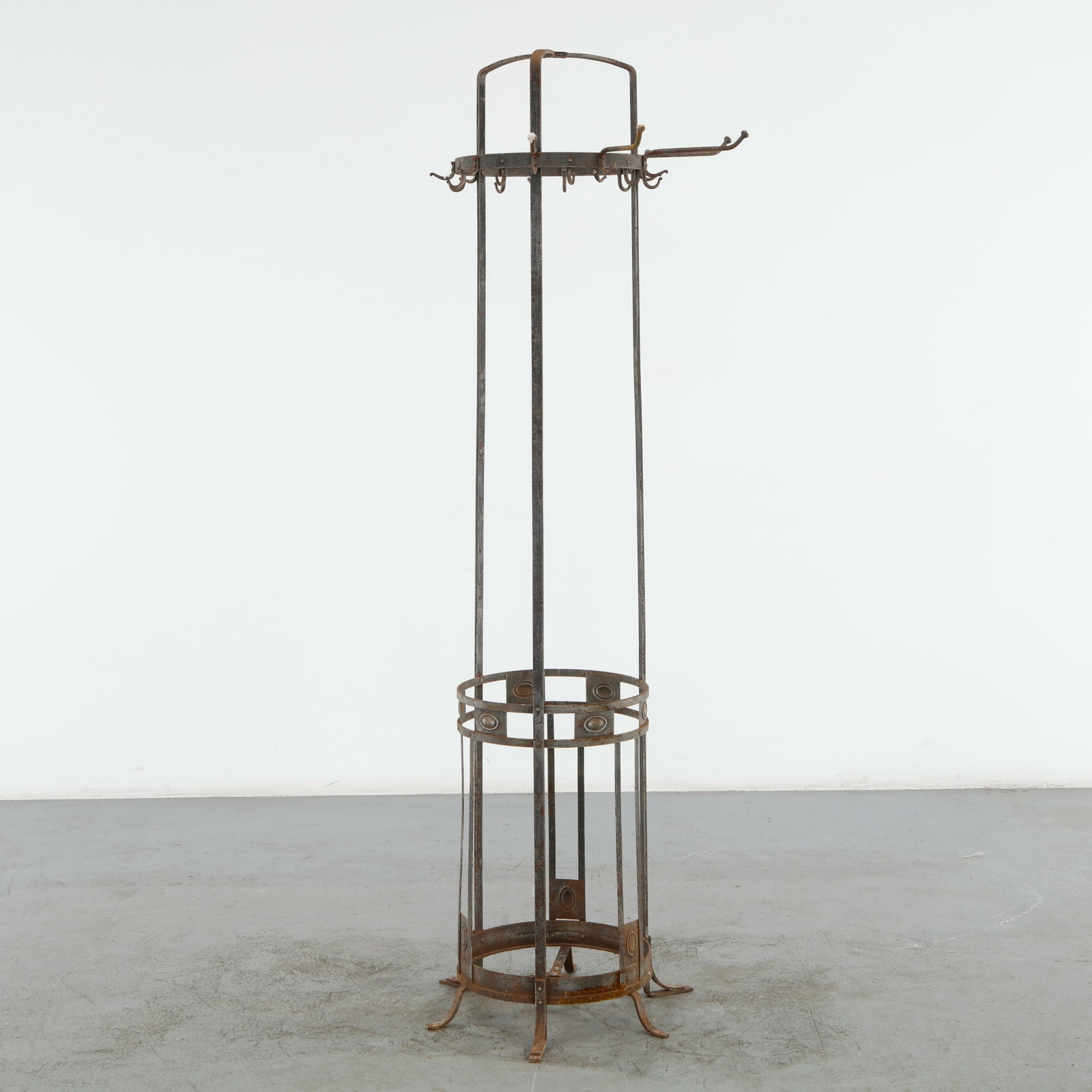 Iron Outdoor Coat Rack, 1960s: Tall outdoor coat rack executed in wrought iron, featuring an open architectural framework with multiple hooks and circular support elements. Its slender vertical profile combines utility with the