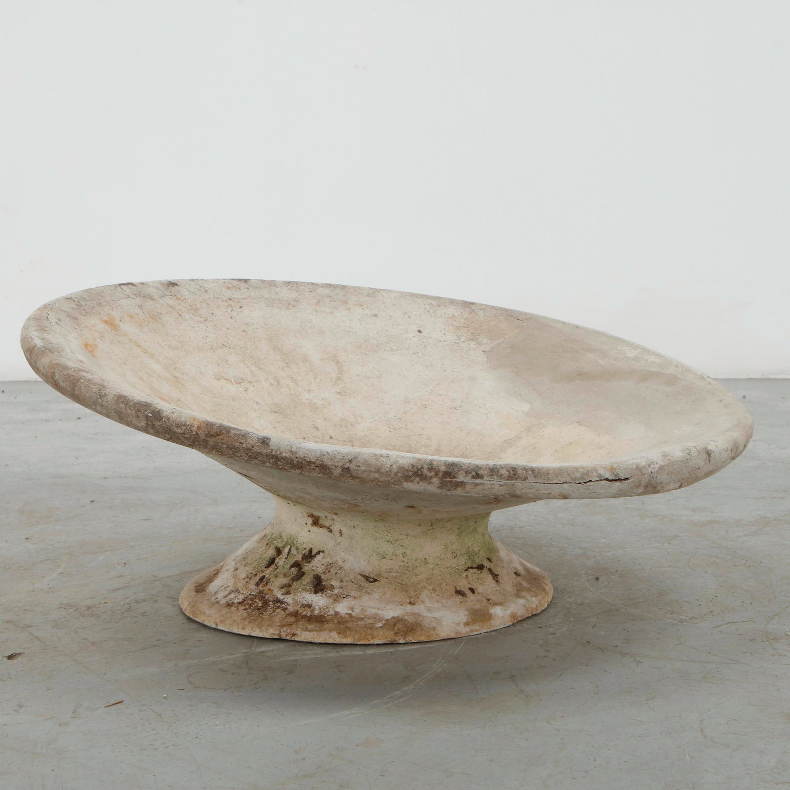 Willy Guhl, Off-Kilter Planter, 1960s: A sculptural concrete planter distinguished by its broad, irregularly undulating profile and generously flared opening. The asymmetrical silhouette and richly weathered surface exemplify Guhl expressi