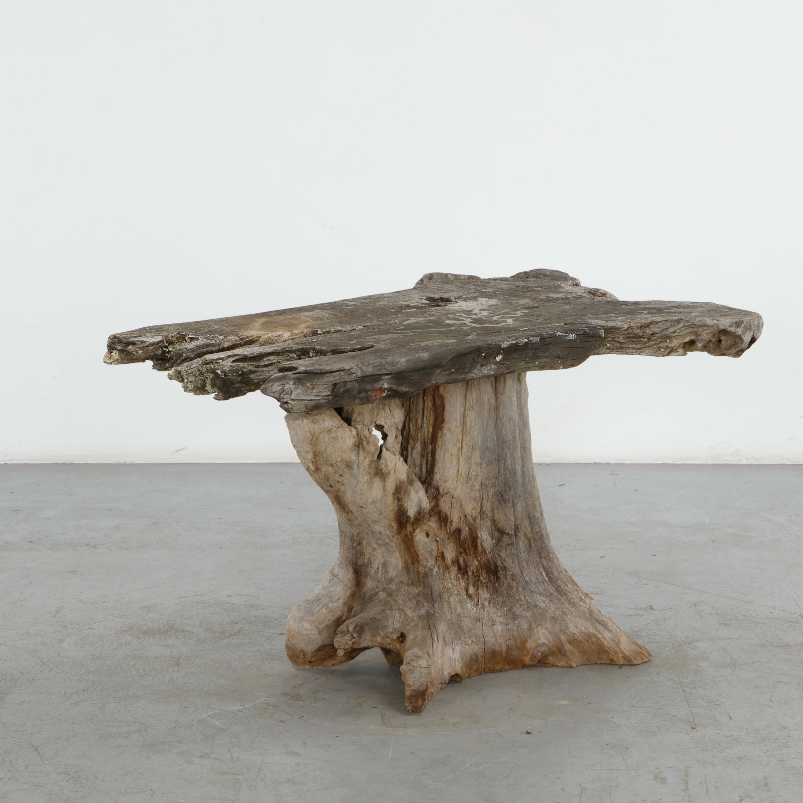 Root Outdoor Dining Table, 1960s: Exceptional outdoor table crafted from a monumental natural root, supporting a broad irregular slab top. The raw organic structure celebrates the material in its most sculptural form, resulting in a