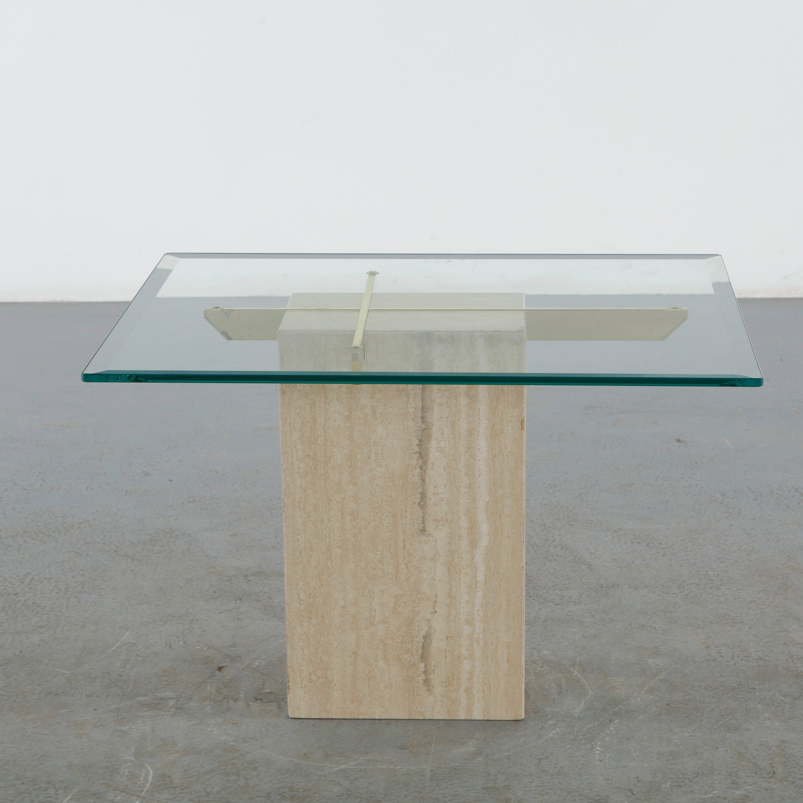 Artedi, Travertine and Glass and Brass Coffee Table, 1970s: Coffee table by Artedi combining a thick glass top with a geometric travertine base and brass supports. The interplay of luxurious materials creates a timeless modern presence. Height: 20.5 in.