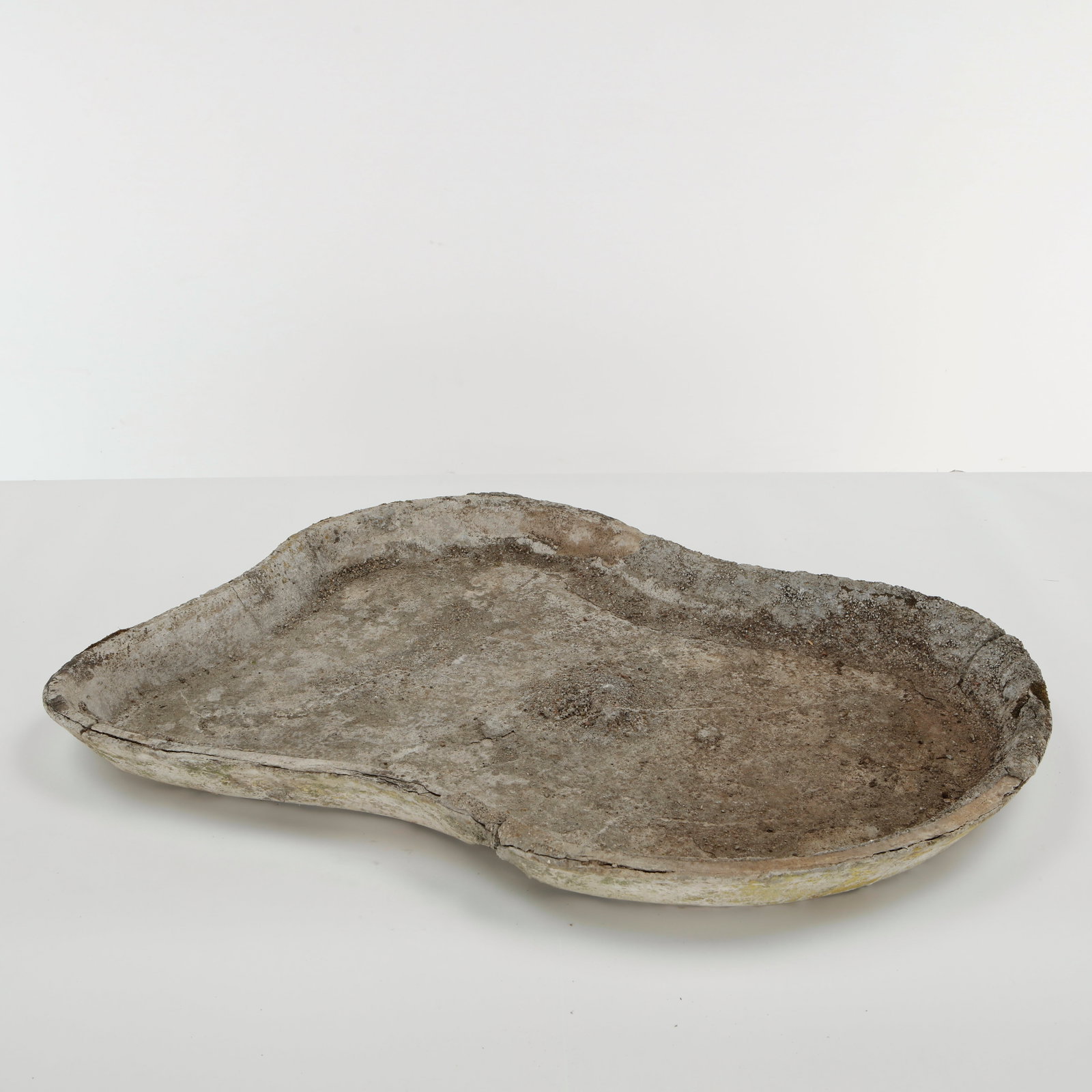 Willy Guhl, Bird Bath Planter, 1960s: Sculptural concrete planter of organically irregular form, with a broad shallow basin and softly undulating rim. The weathered surface bears an expressive patina developed through outdoor exposure,