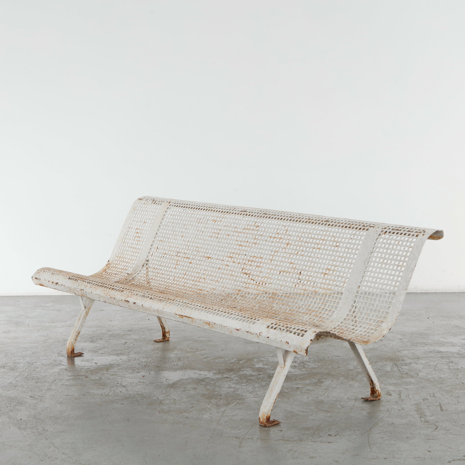 Rene Malaval, White Perforated Metal Bench, 1950s: Rare French outdoor bench by Rene Malaval, executed in perforated painted metal with a graceful continuous structure. The restrained industrial construction and airy perforated surfaces exemplify the 