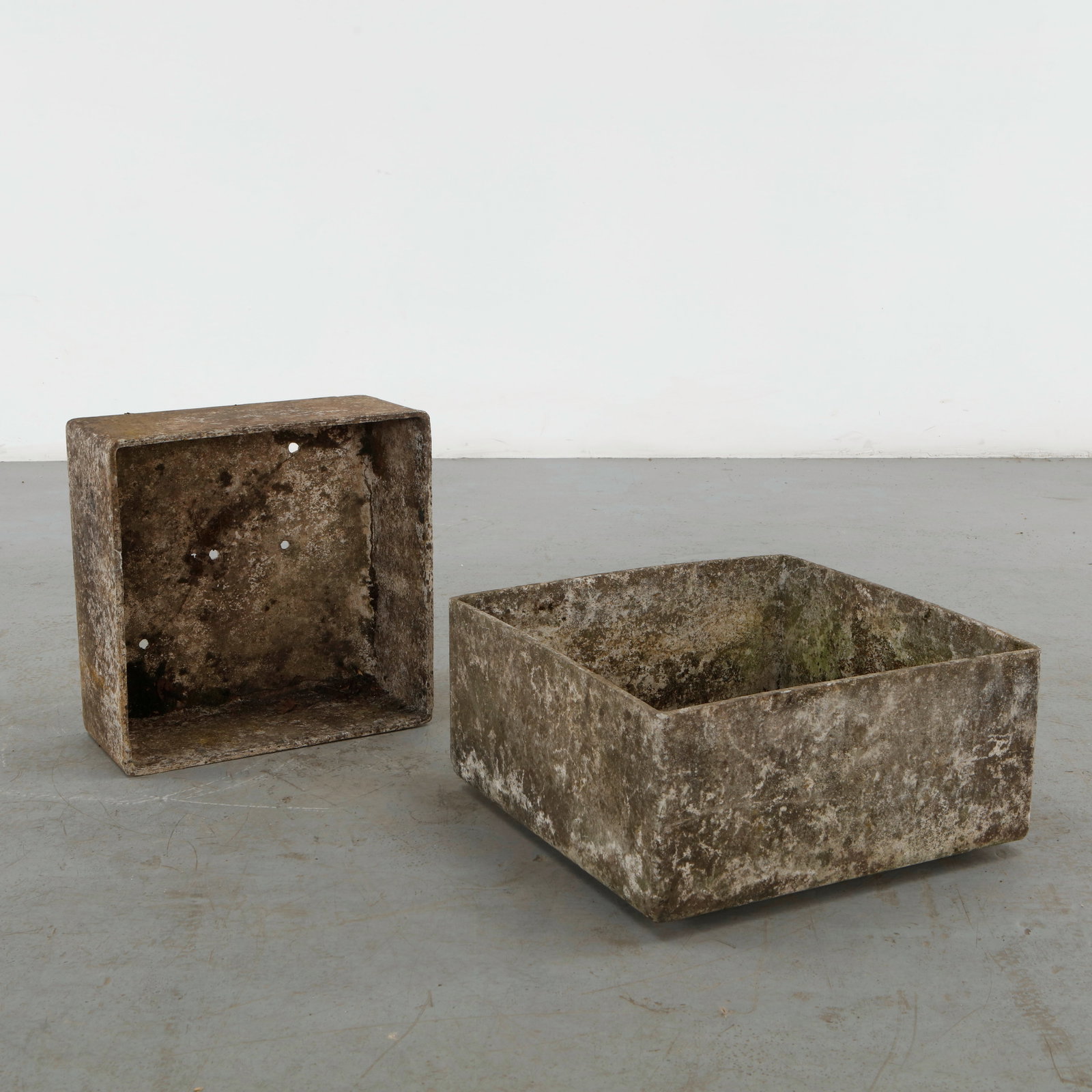 Willy Guhl, Pair of Square Concrete Planters, 1960s: A pair of square planters by Willy Guhl, executed in cast concrete with crisp geometric volumes and softly rounded edges. Their restrained construction exemplifies Guhl characteristic treatment of con