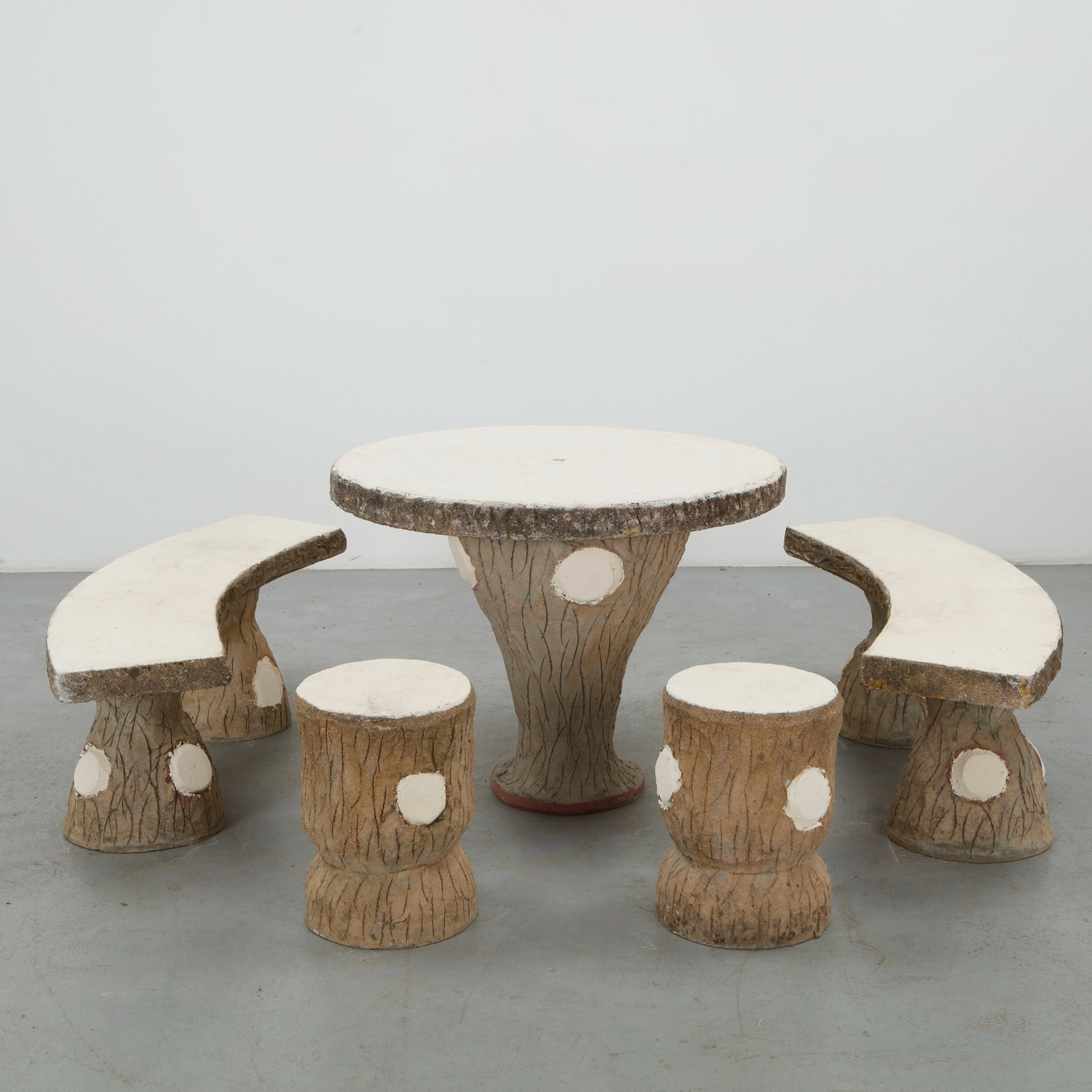 Faux Bois Outdoor Dining Set with Painted White Accents, 1960s: A rare faux bois outdoor dining set comprising a sculptural table and four armchairs, executed in textured concrete to evoke the character of natural timber. Painted white accents enliven the heavily 