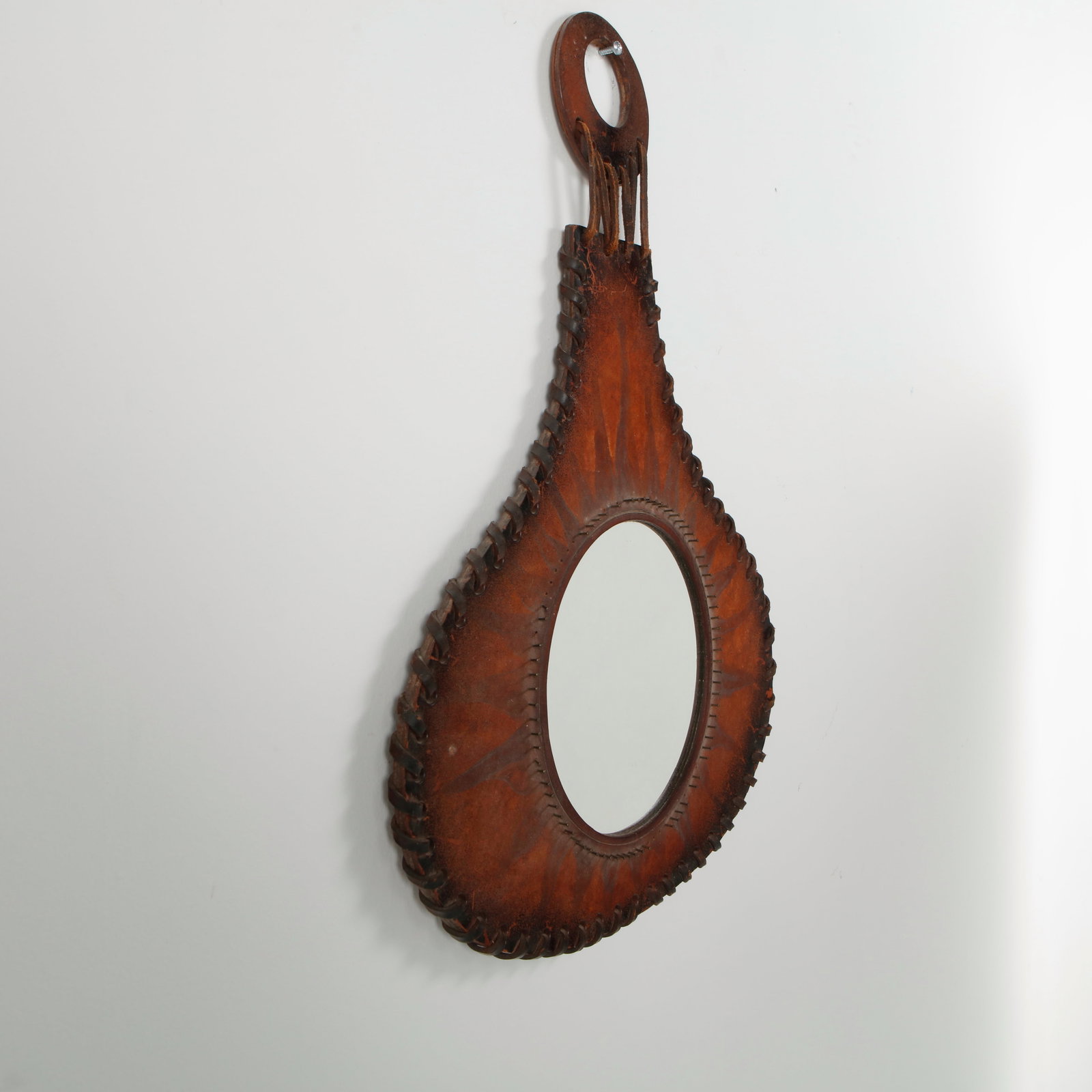 Farkas Klara, Leather Mirror, 1970s: Mirror framed in stitched leather panels, showcasing artisanal craftsmanship and tactile richness. A distinctive piece combining functionality with the refined materiality of midcentury design. Height