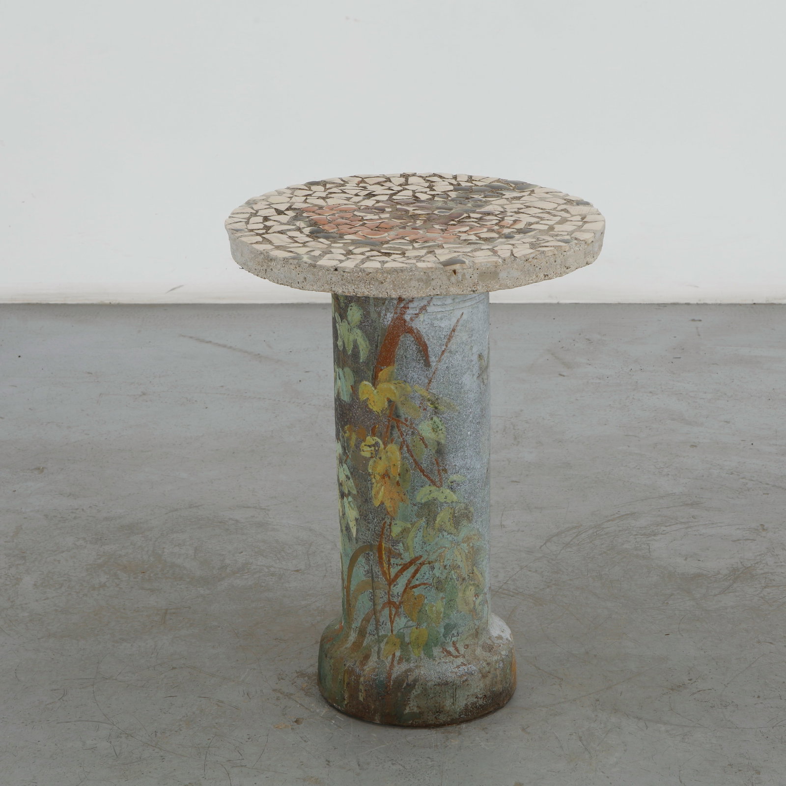 Mosaic Tiles Outdoor Side Table, 1960s: This mid-century mosaic tiles outdoor side table features a charming, artisanal design that perfectly captures the organic, handcrafted aesthetic popular in mid-century garden decor. The circular top