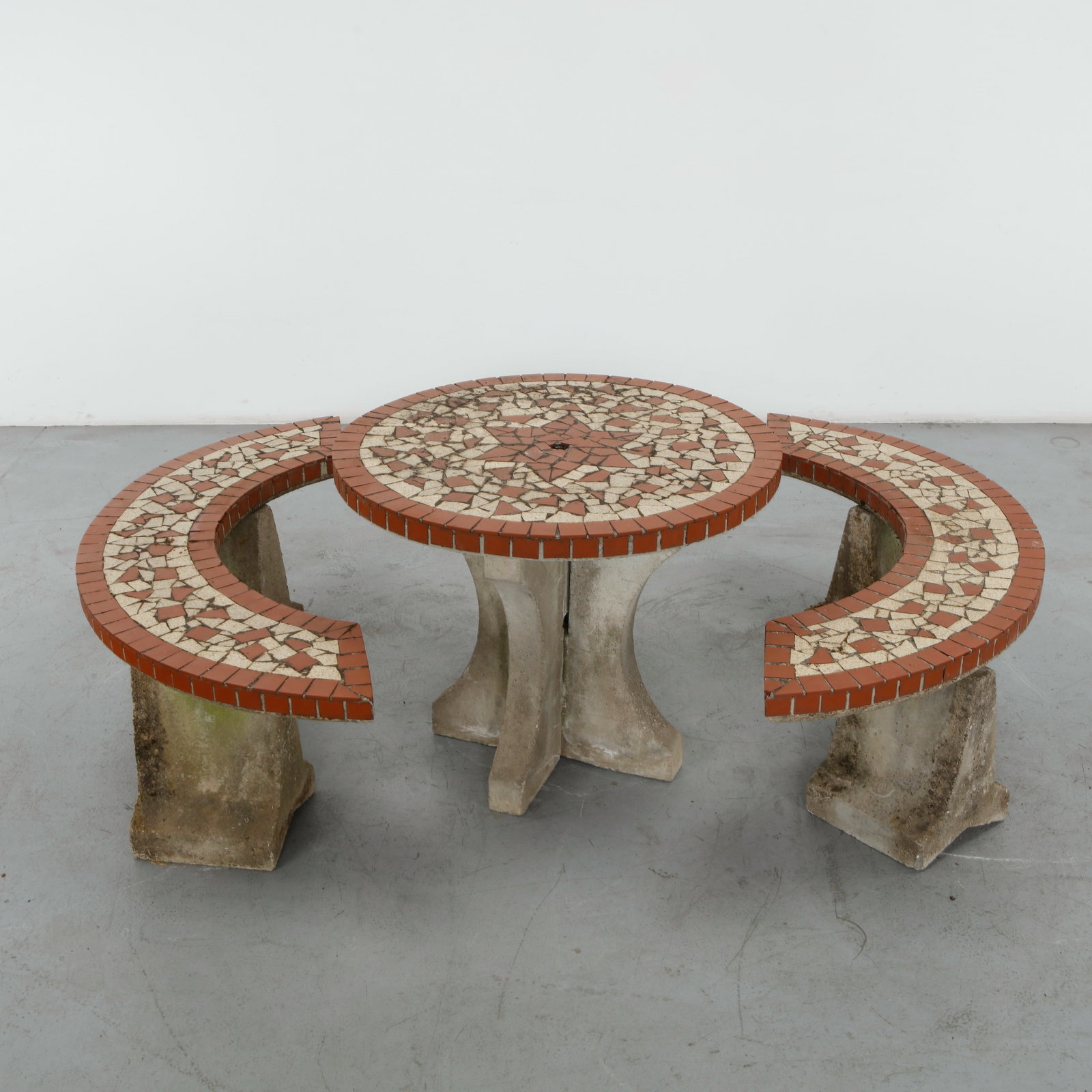 Mosaic Garden Dining Set, 1960s: A classic three-piece brutalist-style mosaic garden dining set comprising round dining table and 2 matching curved benches. The tabletop and seating benches are decorated with a striking mosaic