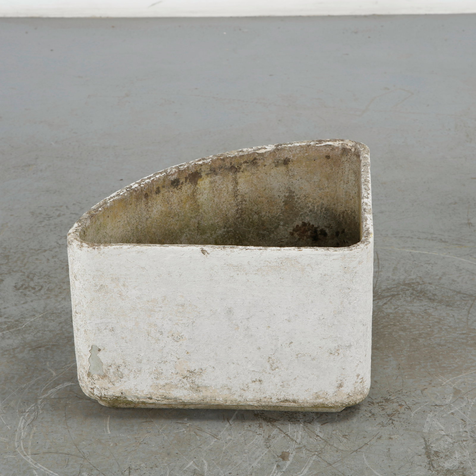 Willy Guhl, Triangular Planter, 1960s: This individual triangular corner planter from Willy Guhl's modular geometric series for Eternit features a distinct wedge or triangular silhouette with a broad, curved front face and two flat