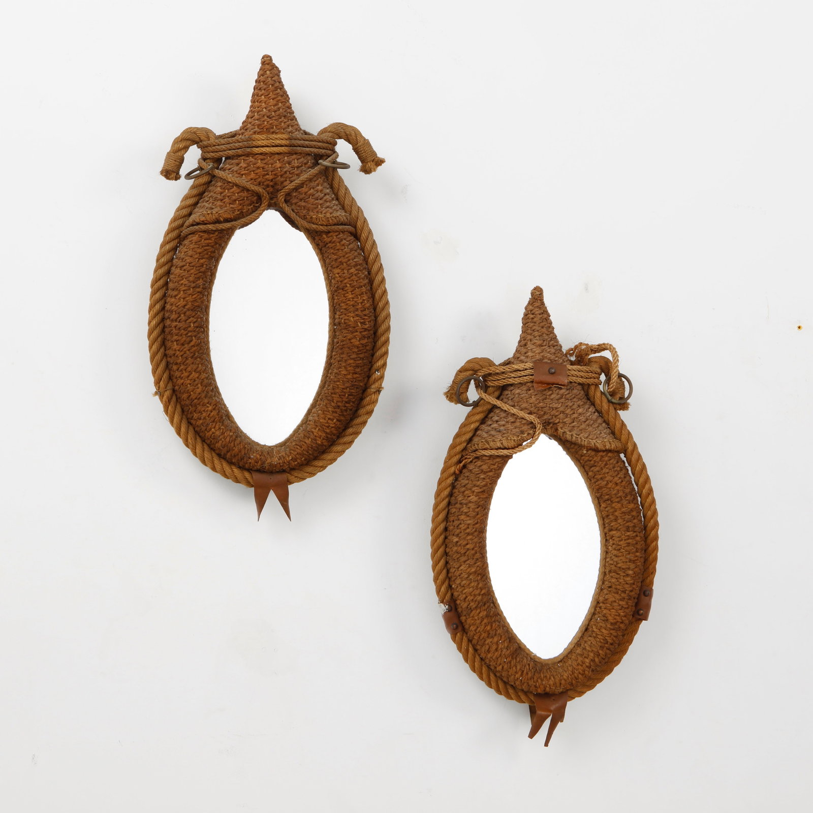 Audoux Minet, Pair of Large Rope Mirrors, 1960s: A rare pair of wall mirrors by Audoux Minet, handwoven in natural rope with sculptural teardrop frames and distinctive nautical detailing. Executed with braided cord, leather accents, and metal fittin
