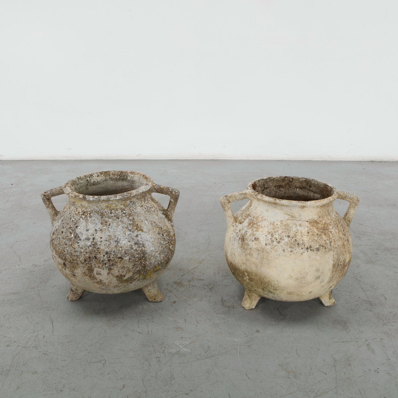 Willy Guhl, Pair of Cauldron Planters, 1960s: Rare cauldron planters by Willy Guhl, with rounded vessel-like shapes and strong sculptural presence. Aged surface adds rustic charm. Opening Diameter: 11 in. Height: 25.5 in. Diameter: 14 in. 