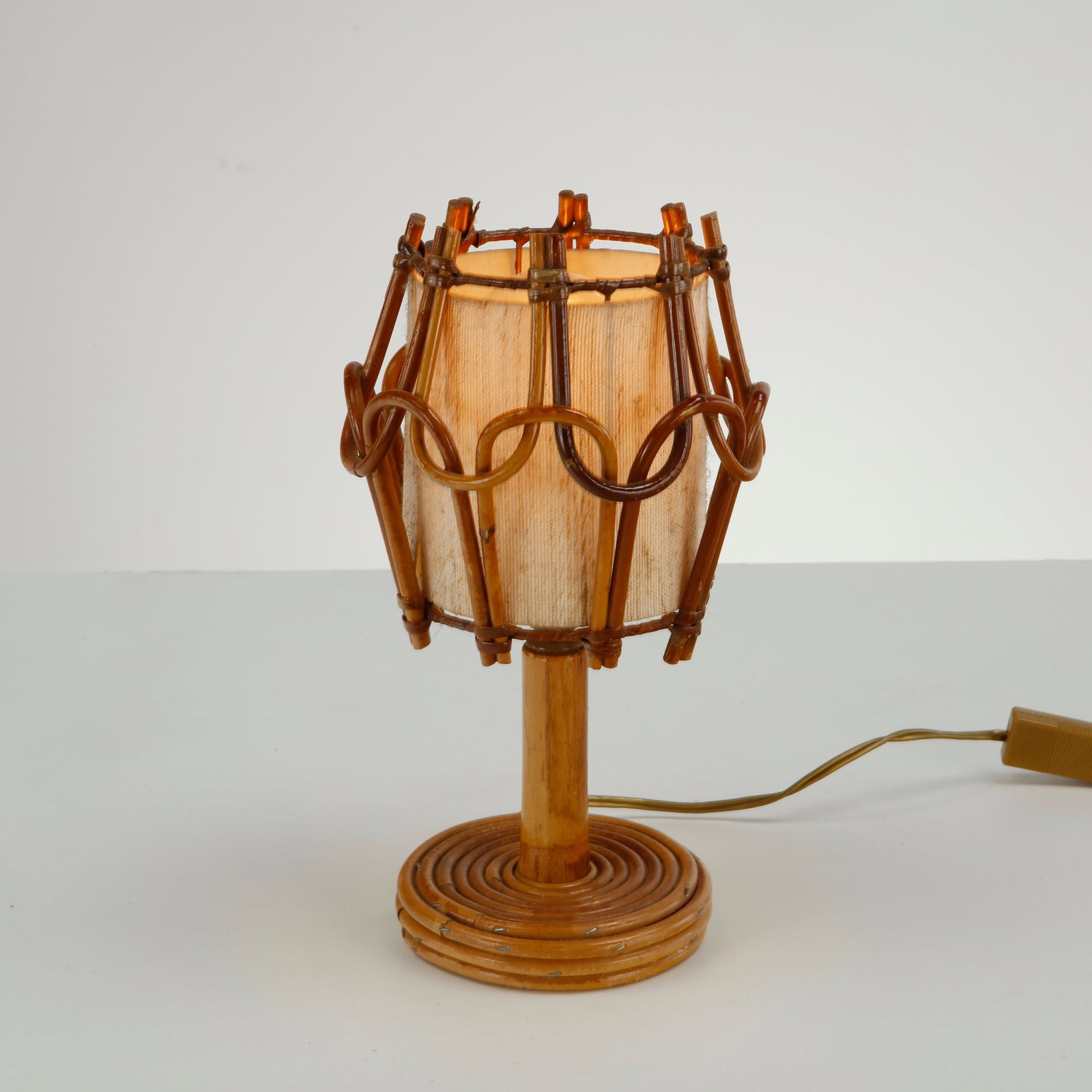 Louis Sognot, Rattan Table Lamp, 1960s: This bamboo and rattan cage table lamp by Louis Sognot is a wonderful example of 1960s French mid-century modern design. Originating from France, this piece showcases the distinctive French Riviera/bo