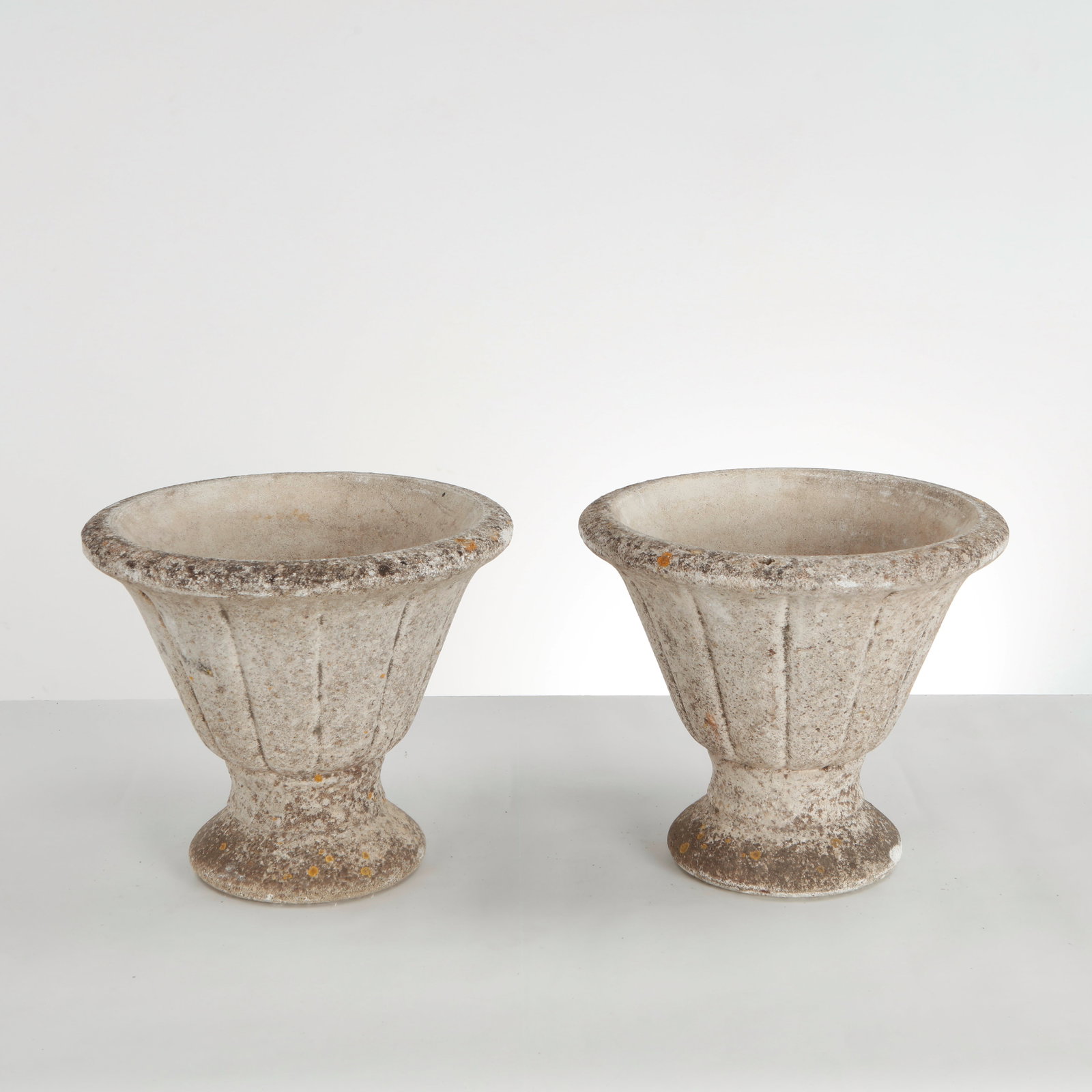 Grandon Fres, Pair of Urn Planters on Stand, 1960s: This pair of vintage cast stone campana urn planters produced by the French manufacturer Grandon Freres in the 1960s_features a classically inspired, flared trumpet silhouette that brings a stately ar