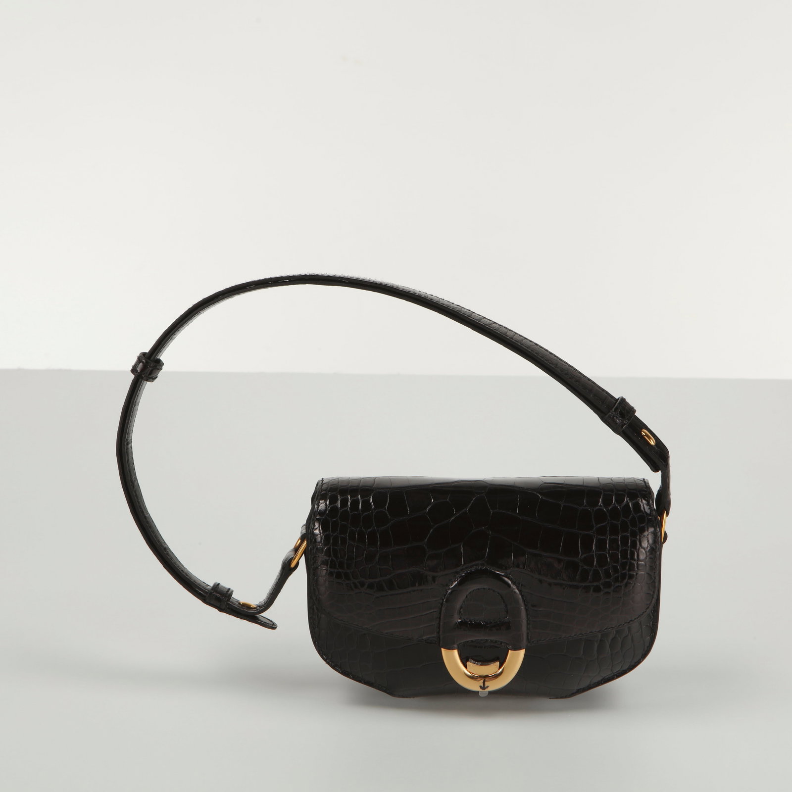 Hermes, Black Shiny Alligator Cherche Midi Mini 18 Gold Hardware: This Hermes Cherche Midi Mini 18 in shiny black alligator with gold hardware is an ultra-luxurious, highly structured statement accessory. Introduced in the mid-2010s, the Cherche Midi line is celebra