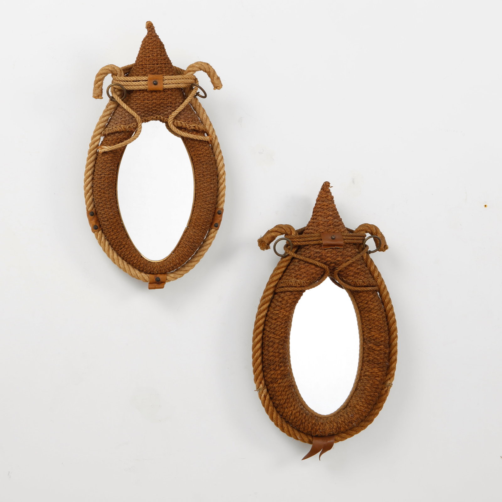 Audoux Minet, Pair of Large Rope Mirrors, 1960s: A rare pair of wall mirrors by Audoux Minet, handwoven in natural rope with sculptural teardrop frames and distinctive nautical detailing. Executed with braided cord, leather accents, and metal fittin