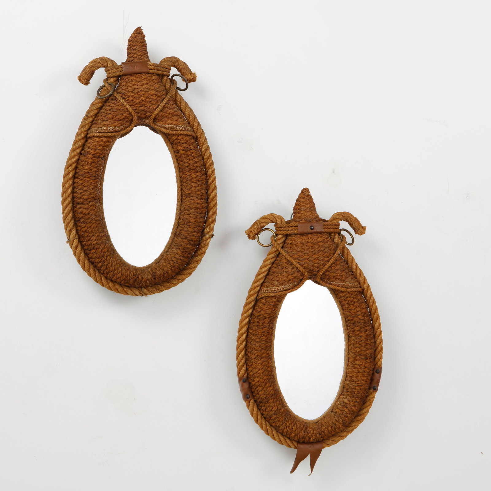 Audoux Minet, Pair of Large Rope Mirrors, 1960s: A rare pair of wall mirrors by Audoux Minet, handwoven in natural rope with sculptural teardrop frames and distinctive nautical detailing. Executed with braided cord, leather accents, and metal fittin