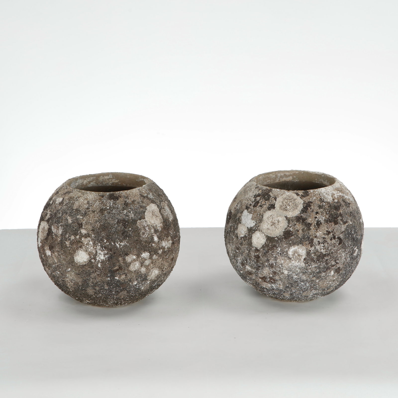 Grandon Fres, Pair of Spherical Planters, 1960s: Pair of spherical planters with textured surface. Sculptural outdoor statement pieces by Grandon Fres. Height: 9.5 in. Diameter: 10 in. Opening Diameter: 6 in. Condition Wear