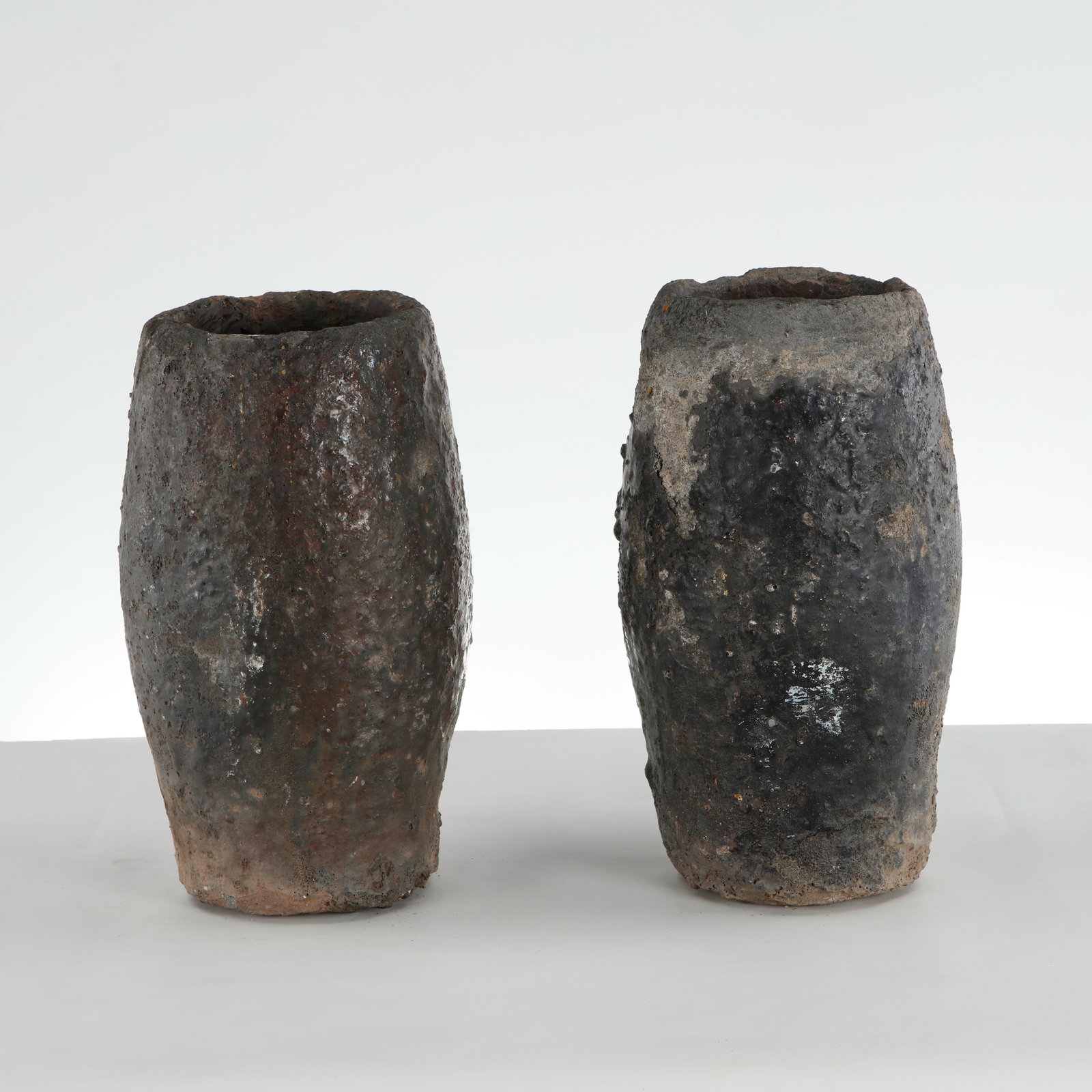 Pair of Small Foundry Planters, 1960s: This pair of vintage industrial foundry crucible planters is an exceptional example of utilitarian object design repurposed as striking, sculptural garden or indoor vessels. 1: Height: 17.5 in. Diamet