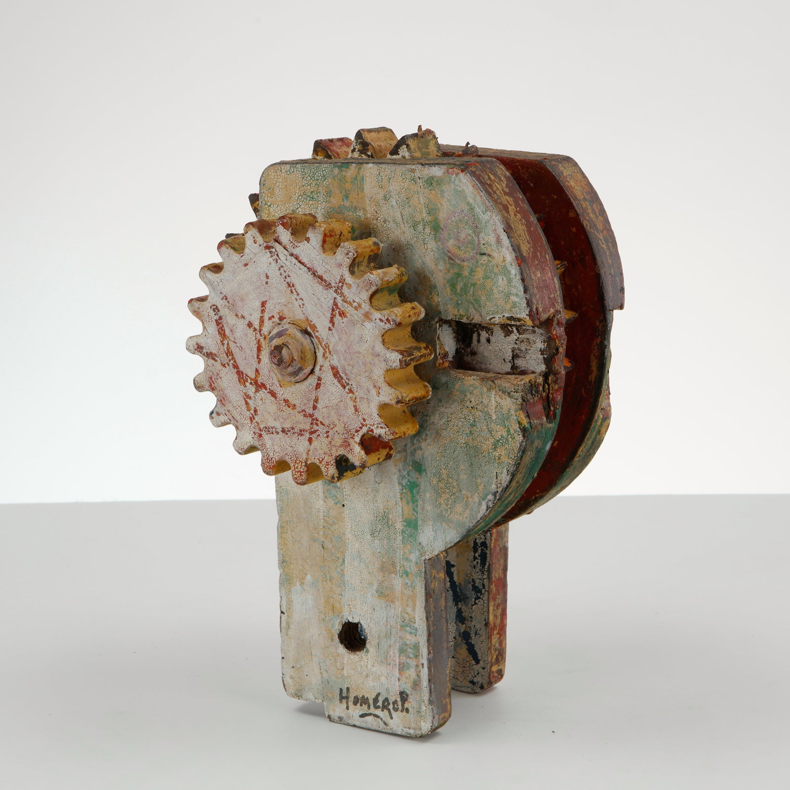 Homerop, Folk Art Painted Wood Gear Sculpture, 1960s: Hand-carved wooden sculpture in the form of interlocking gears, finished in distressed polychrome paint (green, red, yellow, blue) with a central bolt detail. Charming folk art piece with strong indus