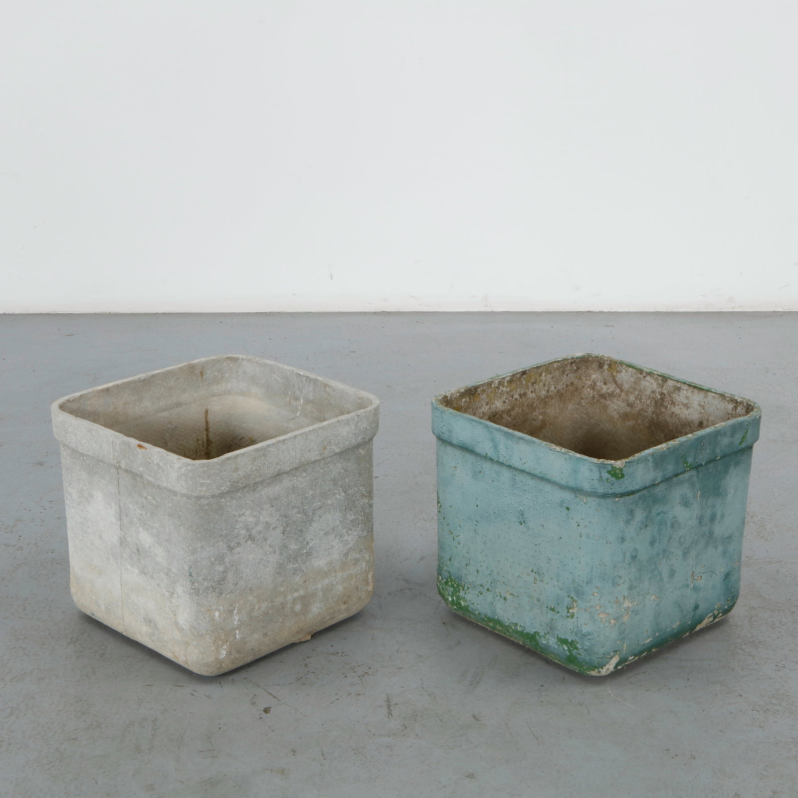 Willy Guhl, Pair of Square Planters, 1960s: A pair of tapering square planters in fiber cement, one left in natural grey concrete, the other finished in pale blue paint with significant loss. Height: 15 in. Length: 16.25 in. Width: 15.25 in. &n