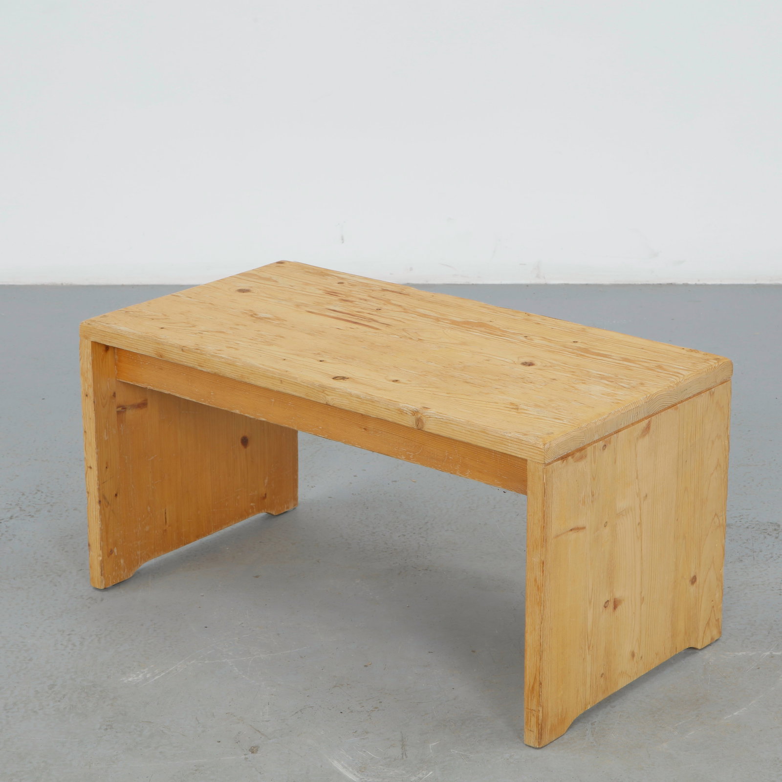 Charlotte Perriand for Les Arcs 1600, Pine Bench, 1960s: A low bench in solid pine, the flat top joined to waterfall sides with exposed joinery. Warm grain and pared back construction reflect the functional vocabulary Perriand developed for Les Arcs 1600.&n