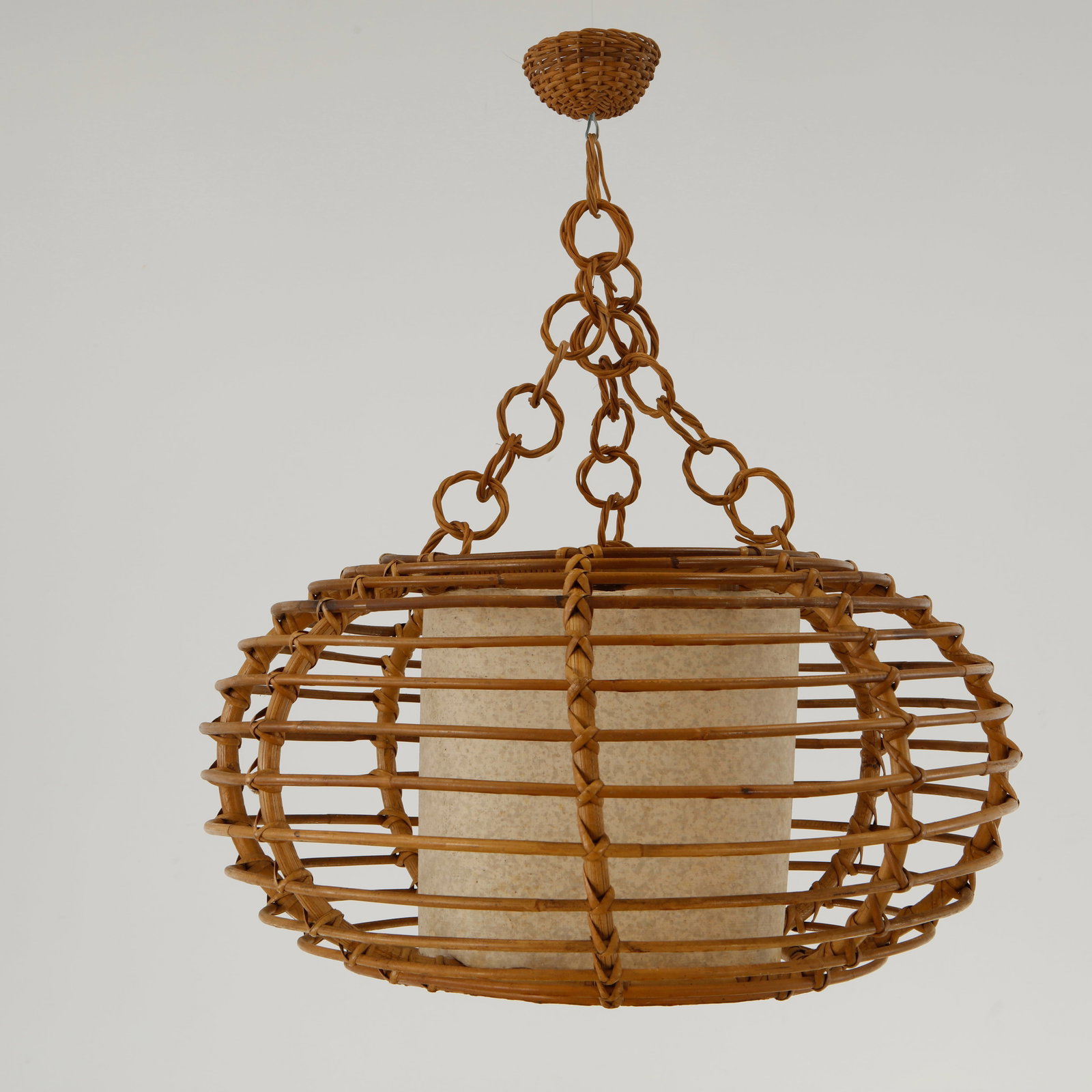Louis Sognot, Oval Rattan Pendant Lamp, 1950s: A suspended lantern featuring an intricate bamboo framework surrounding a parchment diffuser. A rare example of Sognot organic lighting designs inspired by Riviera craftsmanship No electronic disposal