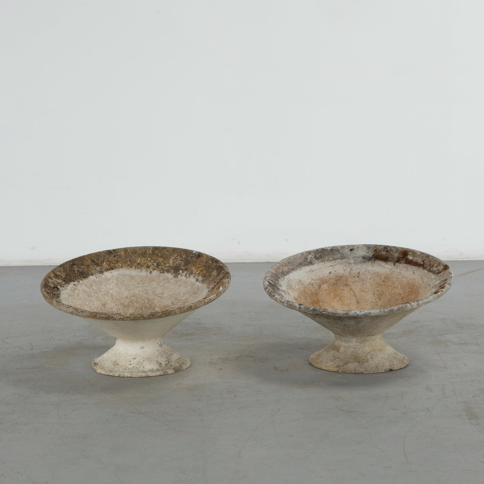 Willy Guhl, Pair of Off Kilter Planters, 1960s: A pair of rare asymmetrical planters by Willy Guhl, featuring a bold modernist design. TOP Diameter: 25 in. BASE Diameter: 13 in. Height: 14.5 in. Condition Wear commensurate with age an